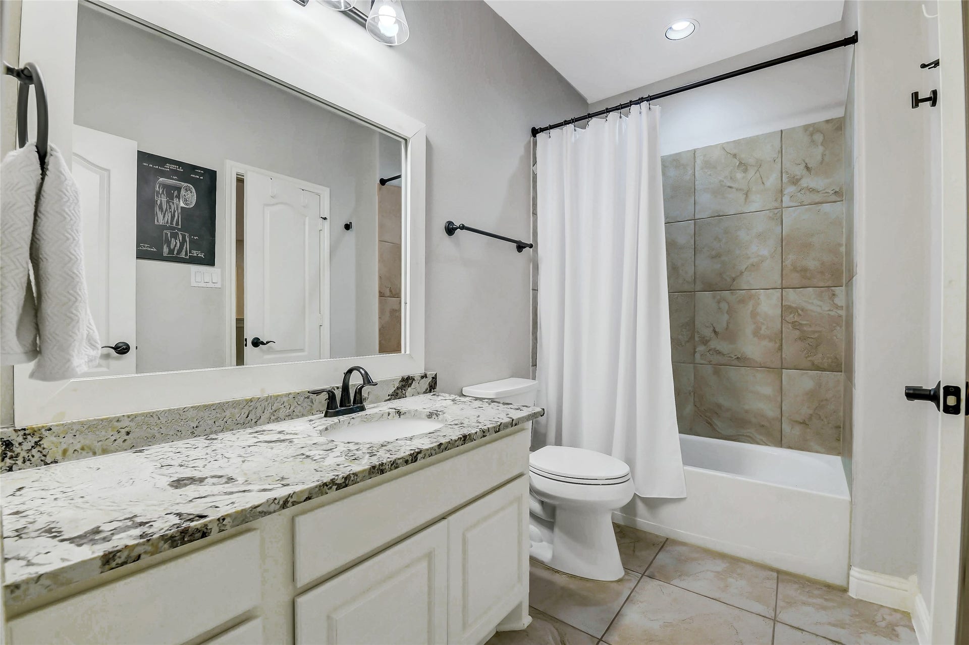 5410 Briarcliff Lane, Fulshear, TX 77441 This upstairs full bathroom offers convenient access from both the adjacent bedroom and the hallway, featuring a granite vanity, tiled tub/shower combination and quality finishes that comfortably serve family members and guests.