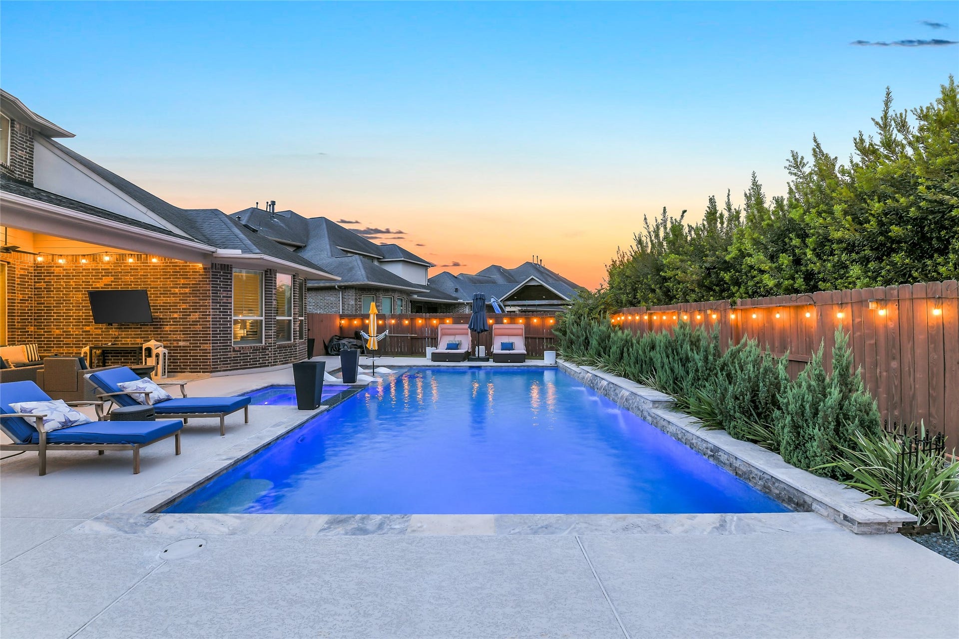 5410 Briarcliff Lane, Fulshear, TX 77441 Resort-style pool with tanning ledge, spa, and spacious patio, perfect for enjoying Houston summers.