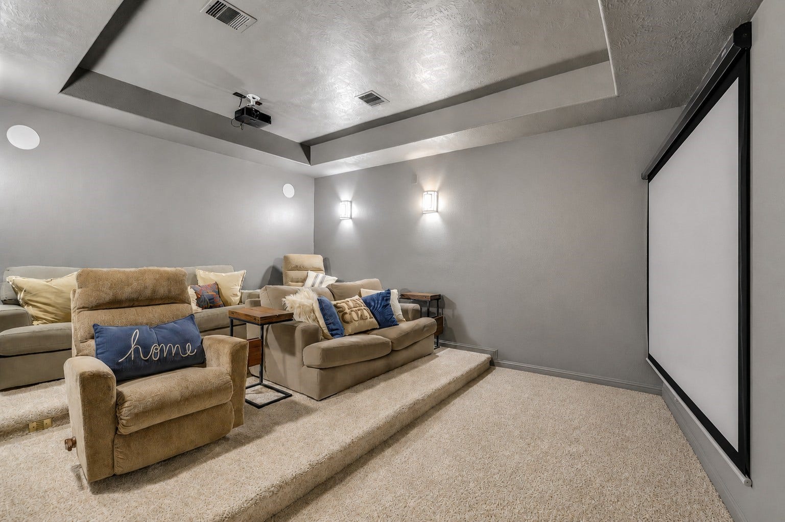 5410 Briarcliff Lane, Fulshear, TX 77441 Private media room featuring stadium-style seating, a projector, and a theater screen for an immersive viewing experience
