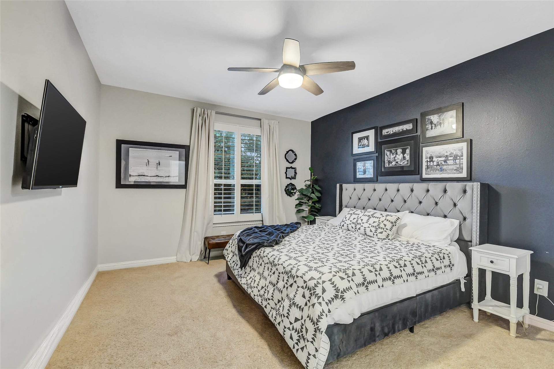 5410 Briarcliff Lane, Fulshear, TX 77441 Front-facing secondary bedroom featuring plantation shutters, a ceiling fan and a spacious walk-in closet.