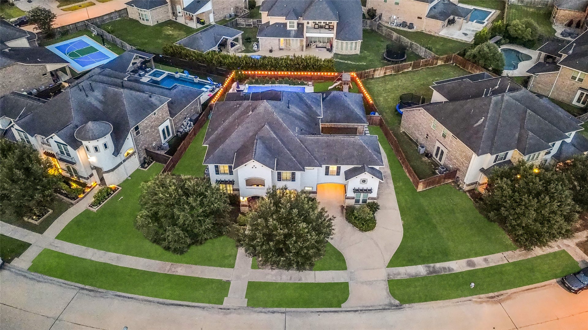 5410 Briarcliff Lane, Fulshear, TX 77441 This aerial view highlights the homes impressive curb appeal, oversized lot and private backyard oasis with a pool and covered patio.