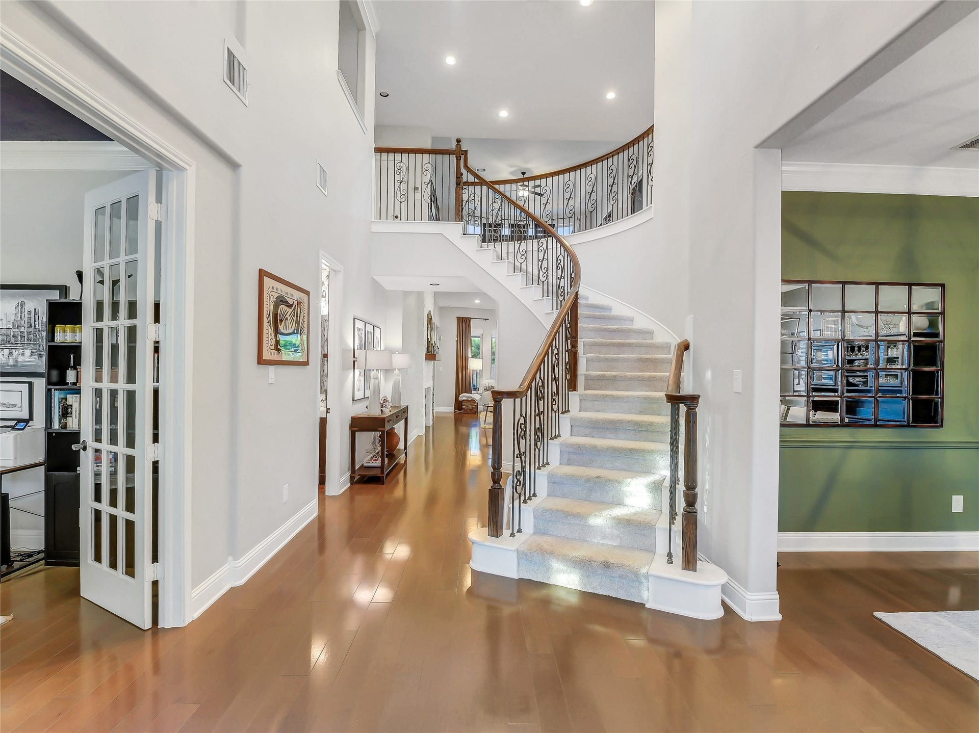 5410 Briarcliff Lane, Fulshear, TX 77441 Enter through double doors to a grand entry with sweeping iron staircase. This elegant entry creates a stunning first impression while offering seamless access to the study, formal dining room, and main living areas.