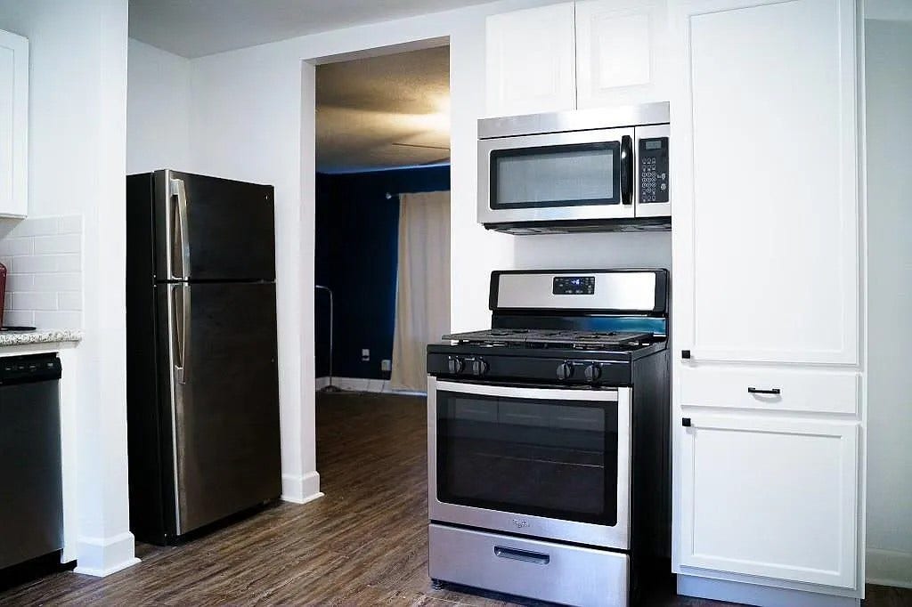 Kitchen with Stainless Steel Appliances Including Microwave and Range