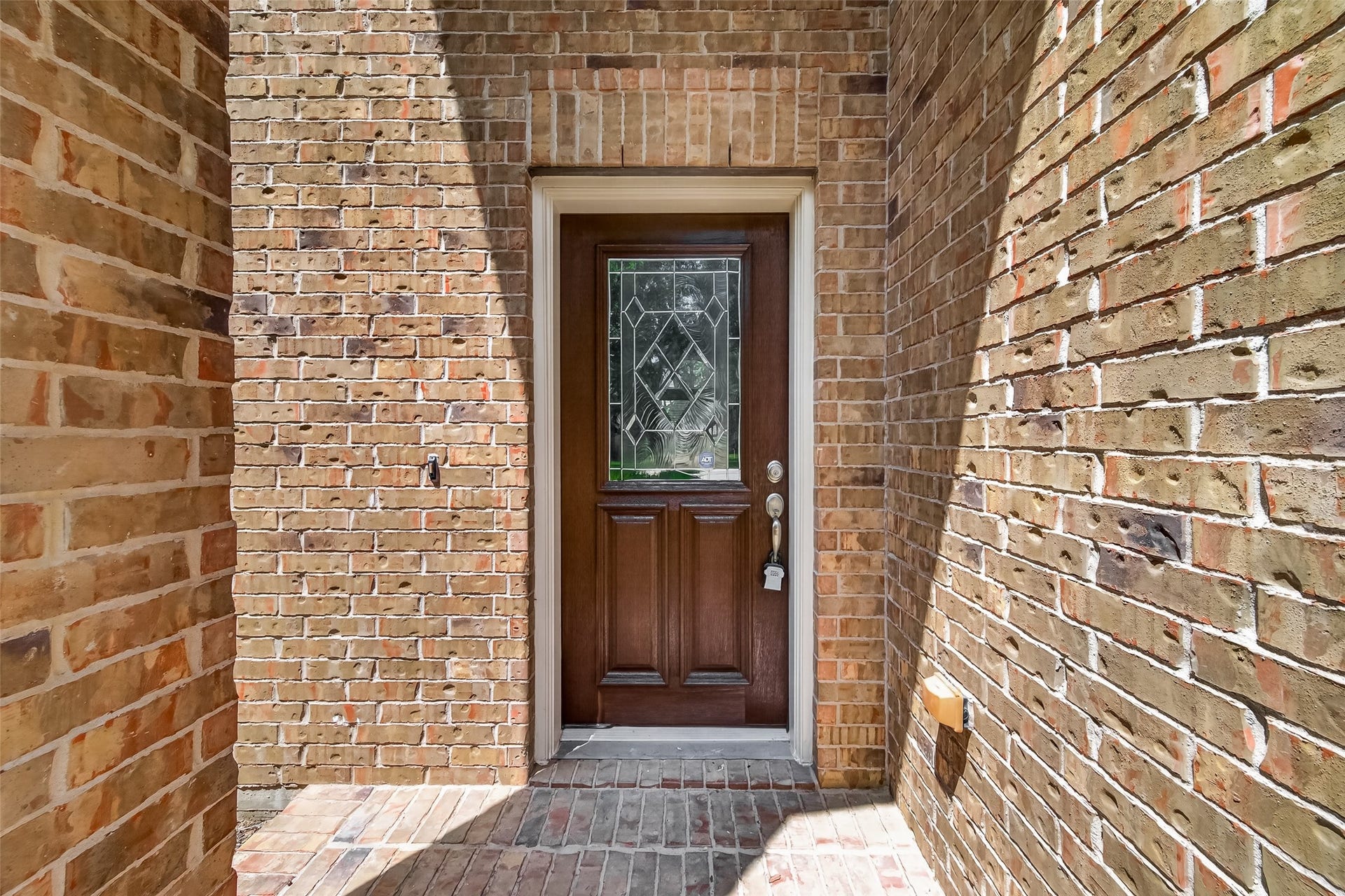 3635 Cottage Manor Lane, Katy, TX 77494 Classic brick exterior and a covered entry with a decorative leaded-glass front door.