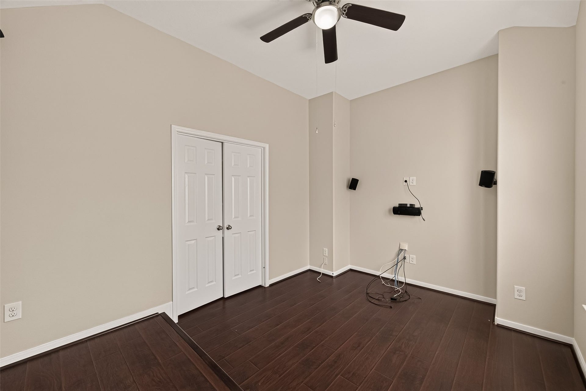 3635 Cottage Manor Lane, Katy, TX 77494 Another view of the flex room, showing the double-door closet, vaulted ceiling, ceiling fan, and raised platform area. It works as a media room, office, or bedroom.