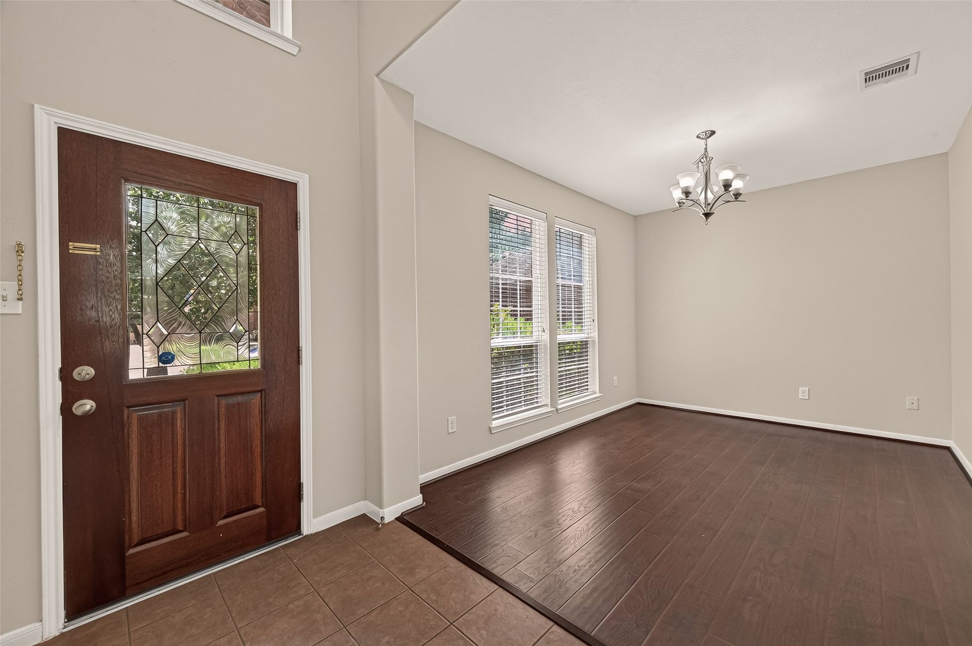 3635 Cottage Manor Lane, Katy, TX 77494 Tile entry flows into the formal dining room, which has wood-look flooring, neutral paint, and abundant natural light.