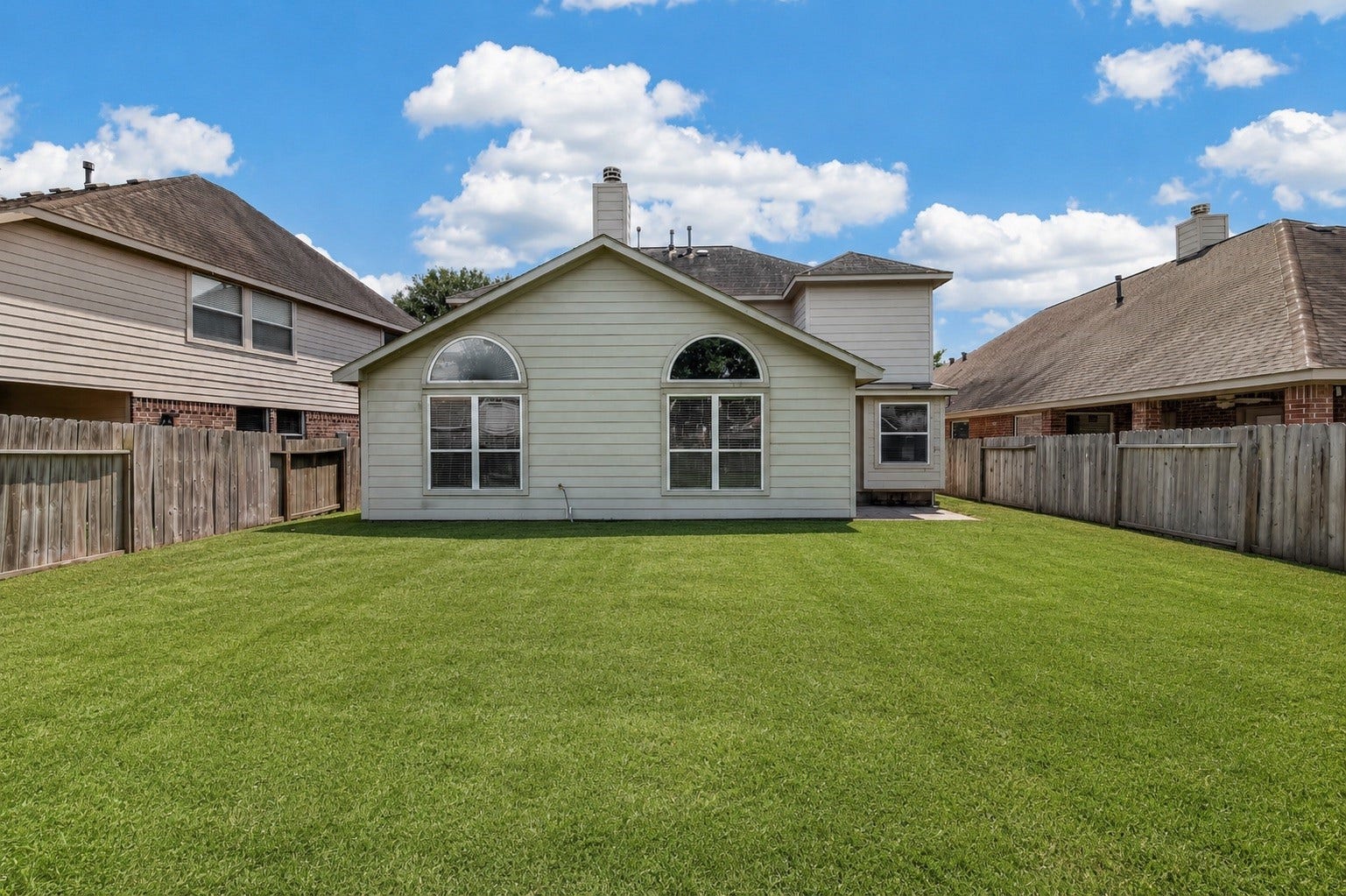 3635 Cottage Manor Lane, Katy, TX 77494 Large, fully fenced backyard with lush green grass and plenty of room to play, garden, or entertain.