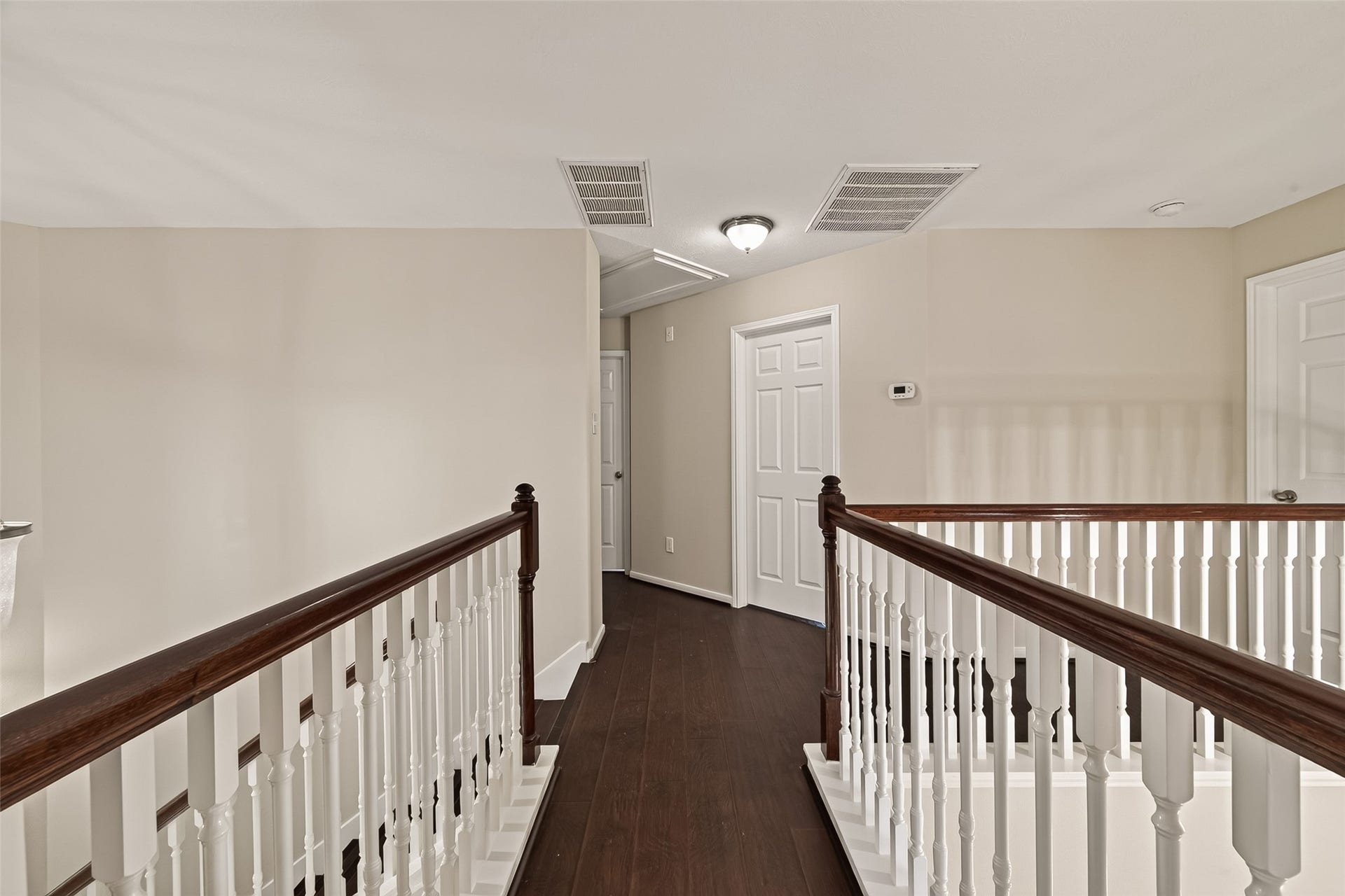 3635 Cottage Manor Lane, Katy, TX 77494 Catwalk landing with stained handrails and white spindles, connecting the upstairs rooms.