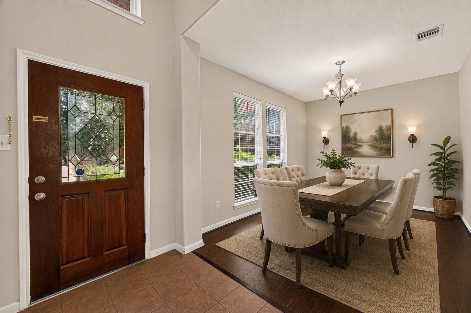 3635 Cottage Manor Lane, Katy, TX 77494 Welcoming entry with a leaded-glass front door that opens to a formal dining room with a chandelier and twin windows.