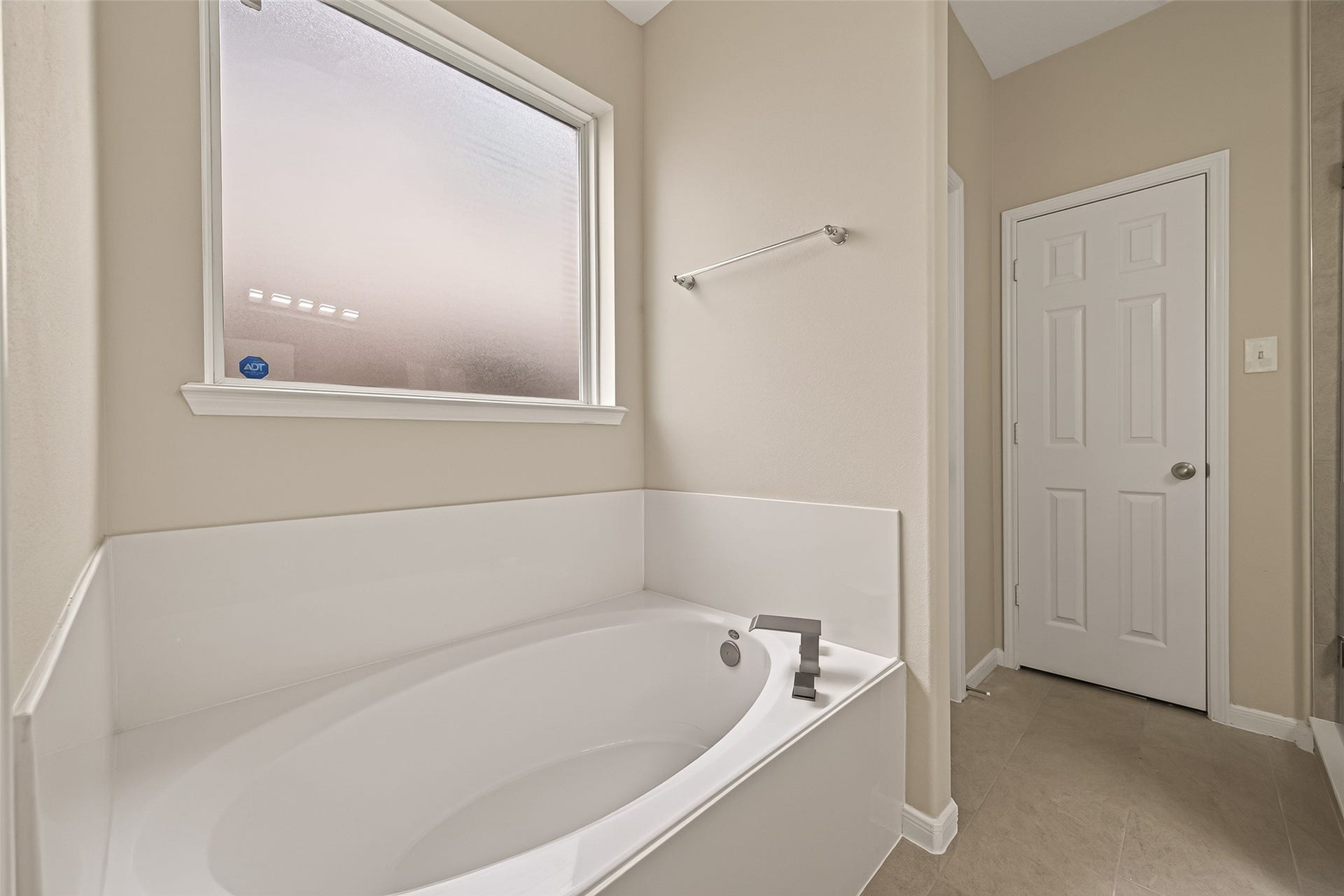3635 Cottage Manor Lane, Katy, TX 77494 Garden tub with a modern brushed-nickel filler and a privacy glass window.