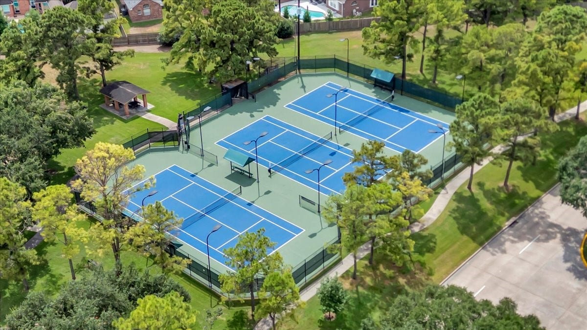 Enjoy Green Trails Park amenities, including two community pools, a splash pad, tennis and pickleball courts, six parks with playgrounds, and miles of walking trails.