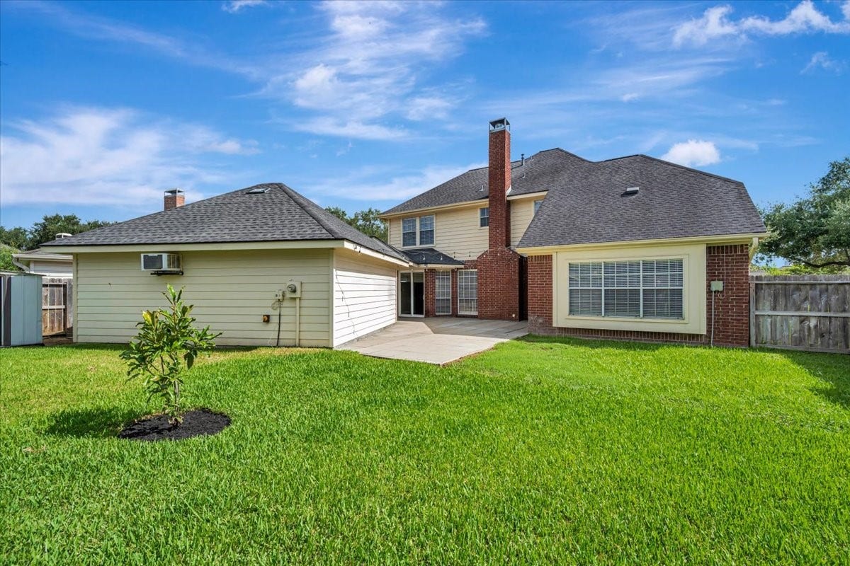 Backyard perspective showing the homes outdoor living potential.