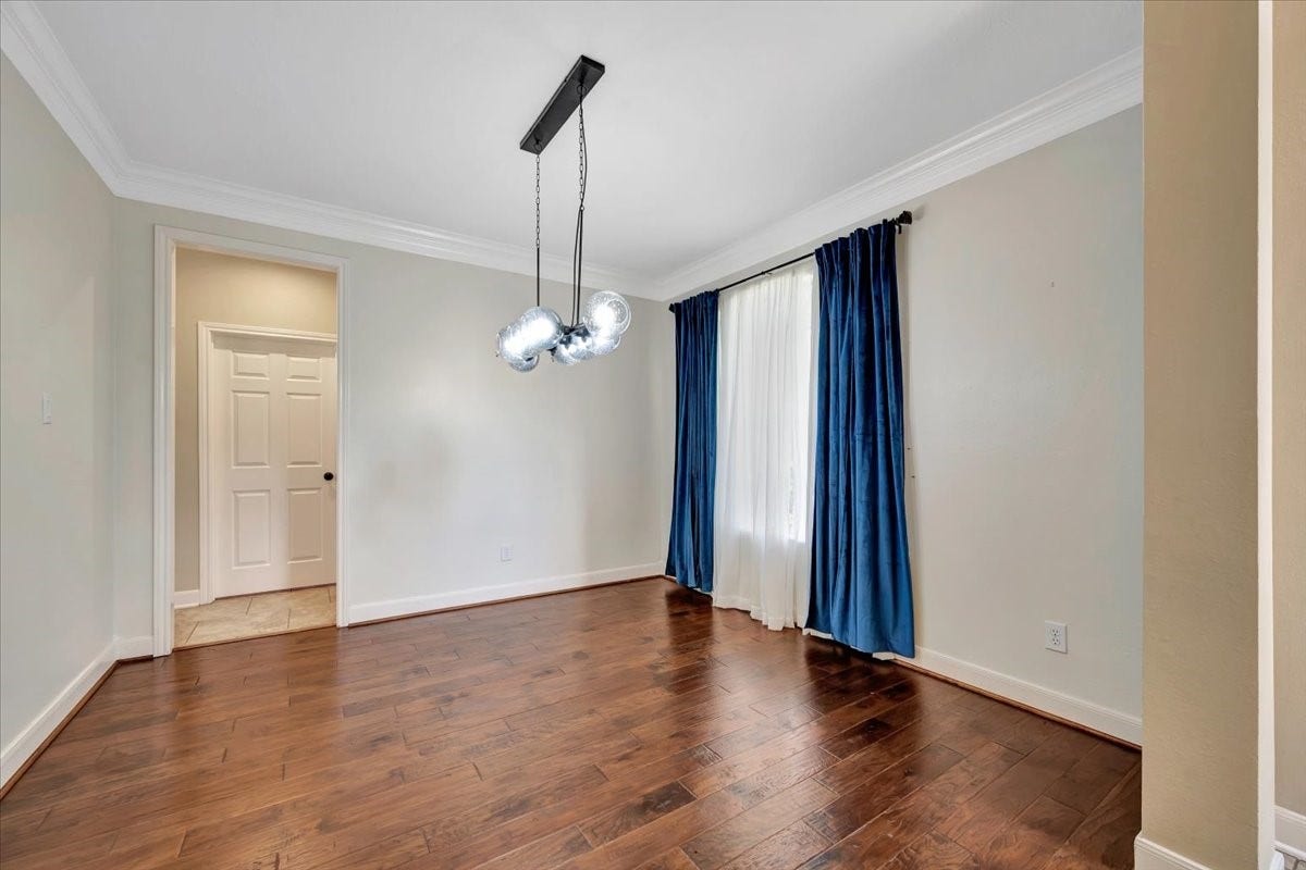 Formal dining room with a chandelier and abundant natural light. Located at the front of the house.