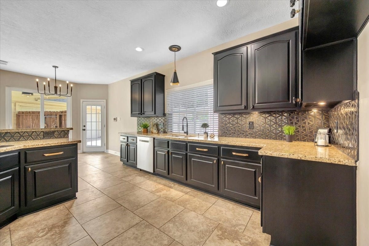 Kitchen view highlighting the generous counter space and breakfast bar.