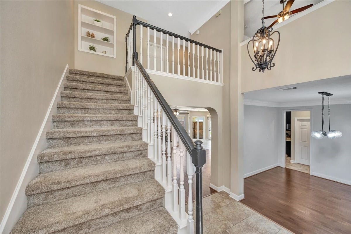 Upstairs landing with convenient built-in shelving, leading to the game room and secondary bedrooms.