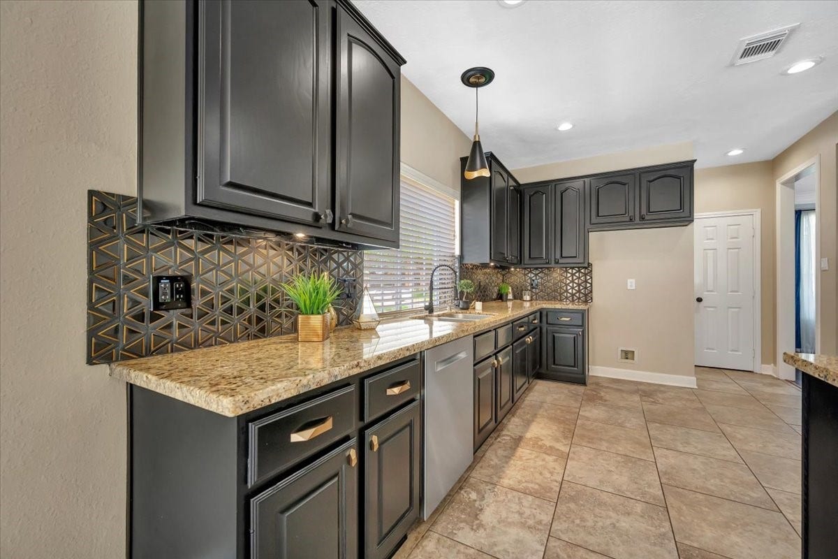 Updated kitchen with granite countertops, stainless steel appliances, and ample cabinetry.