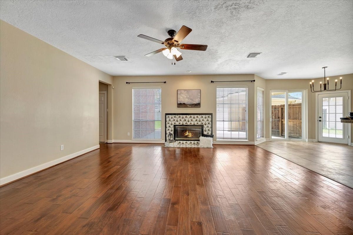 Elegant formal living room featuring a stunning updated fireplace with a marble surround and high-end finishes.