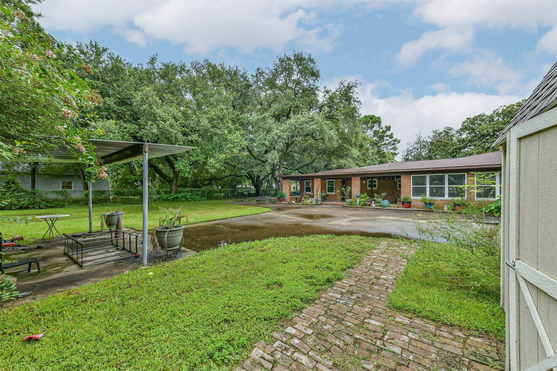 623 Laurel Street, La Marque, TX 77568 Back of house showing back covered patio, 2 car carport. Storage building stays.