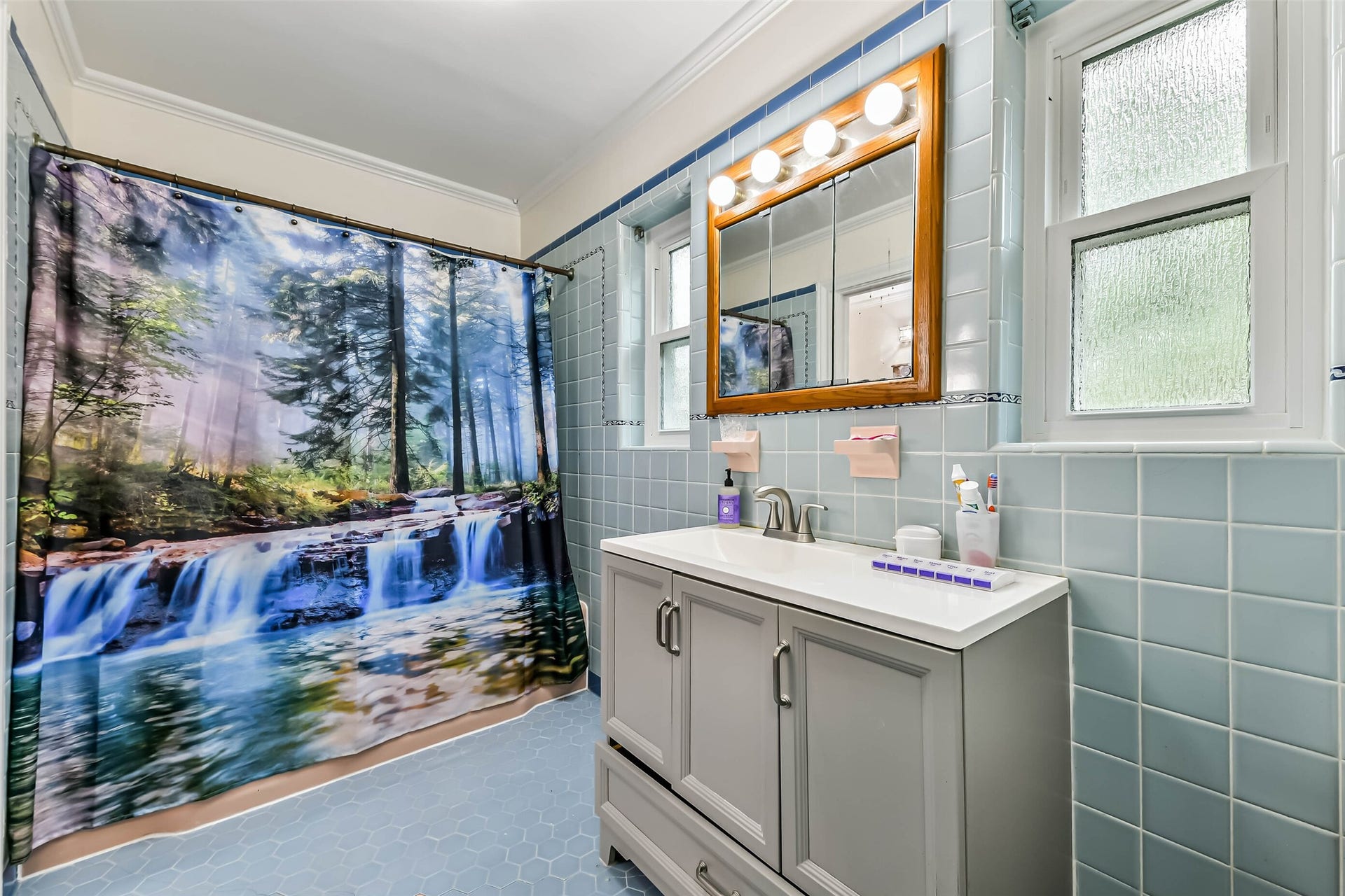623 Laurel Street, La Marque, TX 77568 Master bathroom with tub and shower. Large newer cabinet, new windows!
