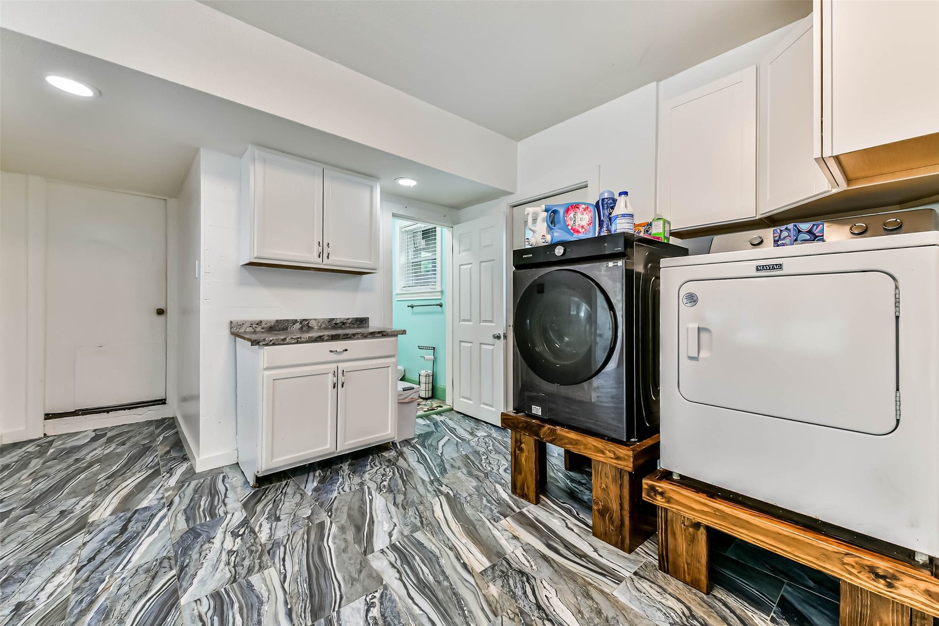 623 Laurel Street, La Marque, TX 77568 Cabinet area for a microwave or coffee pot with storage. Washer dryer located in the garage conversion. Door left of dryer is the full bath for the garage conversion.