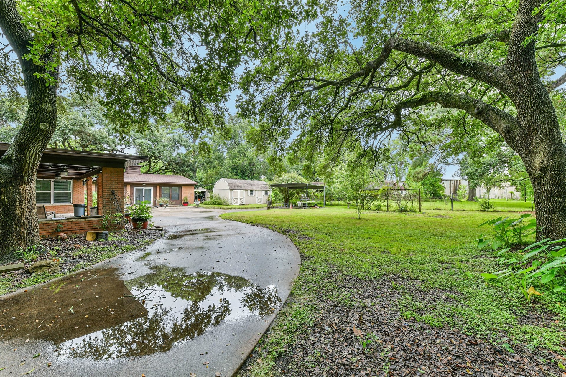 623 Laurel Street, La Marque, TX 77568 The rest of the driveway past gate leading to the carport and garage conversion.