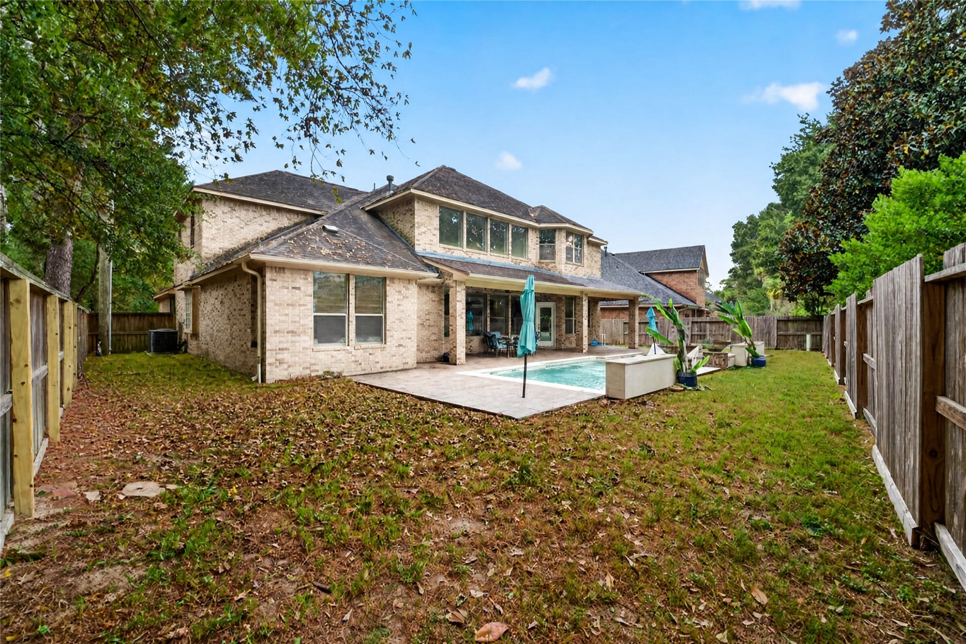 12455 Cedar Breaks Court, Humble, TX 77346 Good yard space behind the pool and on both sides of the house.