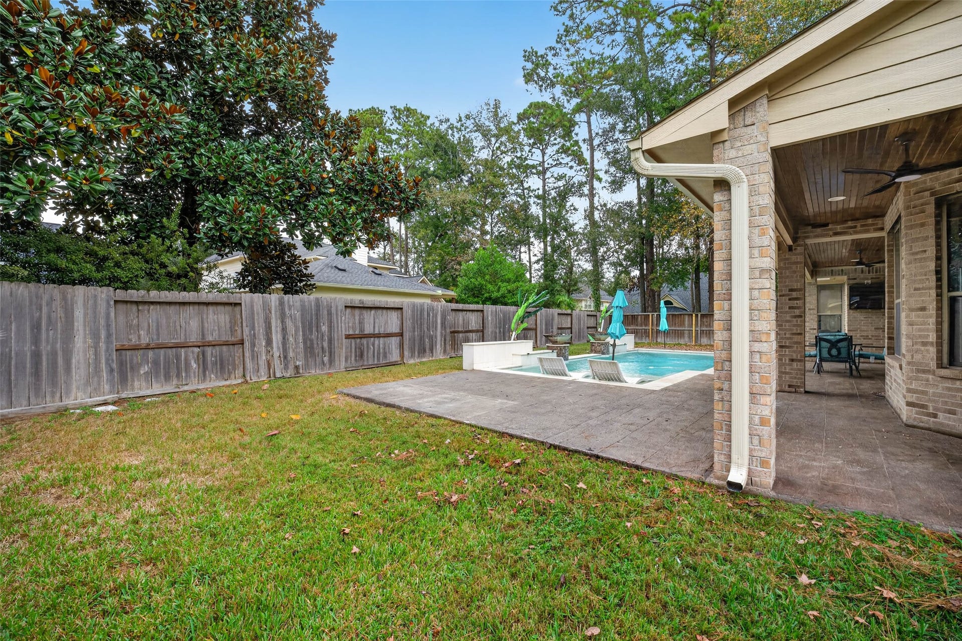 12455 Cedar Breaks Court, Humble, TX 77346 A view from the side yard with a gated entrance for lawn crews.