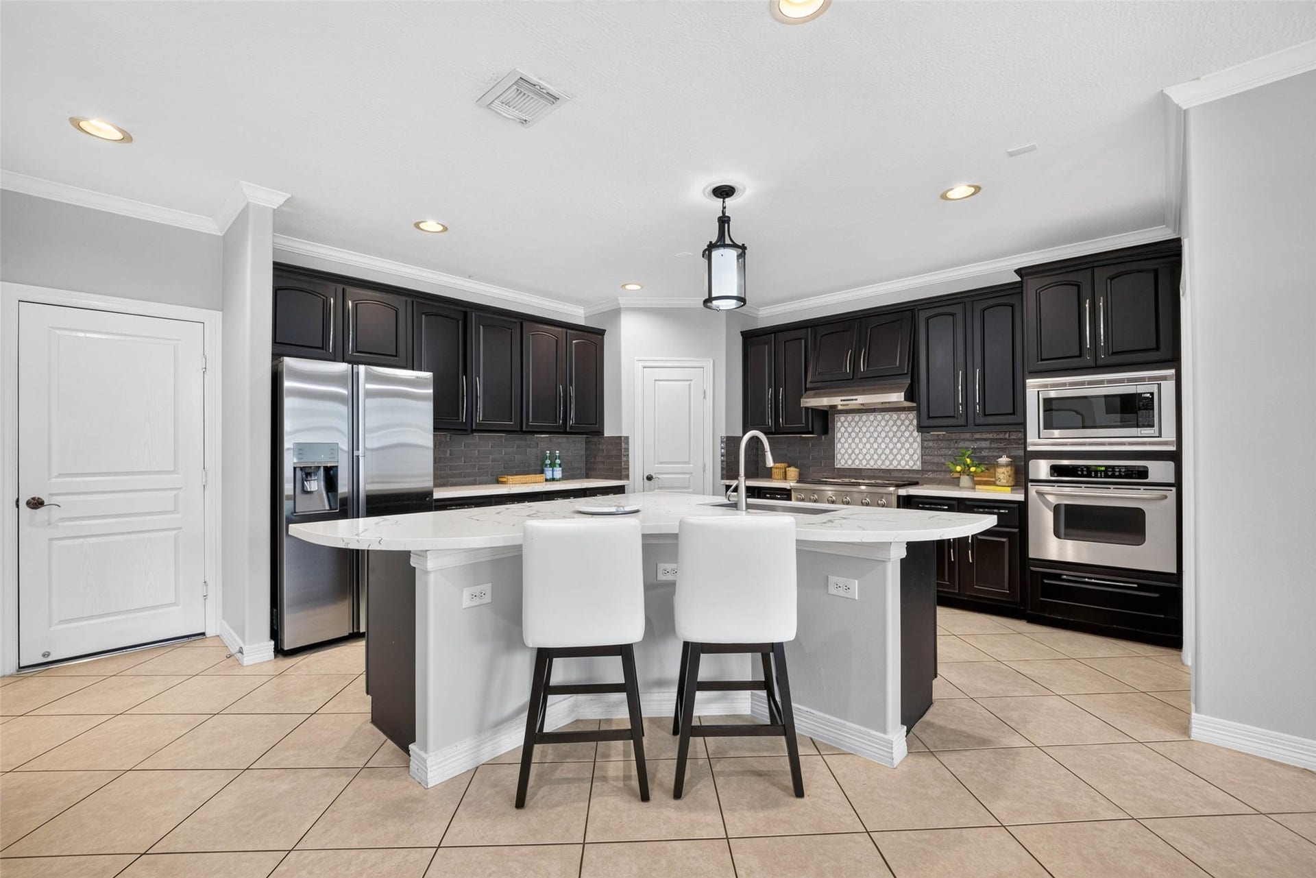 12455 Cedar Breaks Court, Humble, TX 77346 A fully updated Kitchen with Quarts counters, stainless appliances, ceramic backsplash and new fixtures.