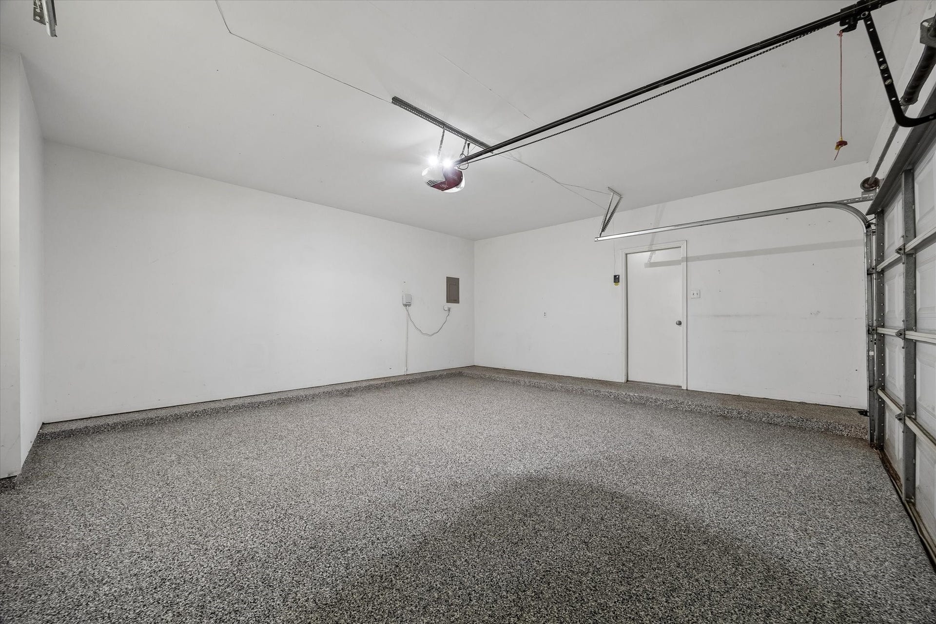 Two-car attached garage features an epoxy-coated floor for a clean, finished look.