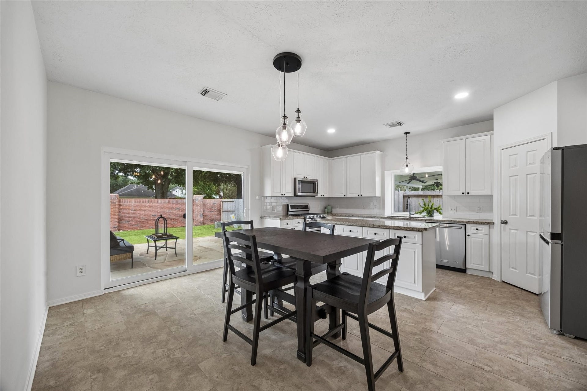 Bright dining area opens to the kitchen and overlooks the backyard and covered patio.