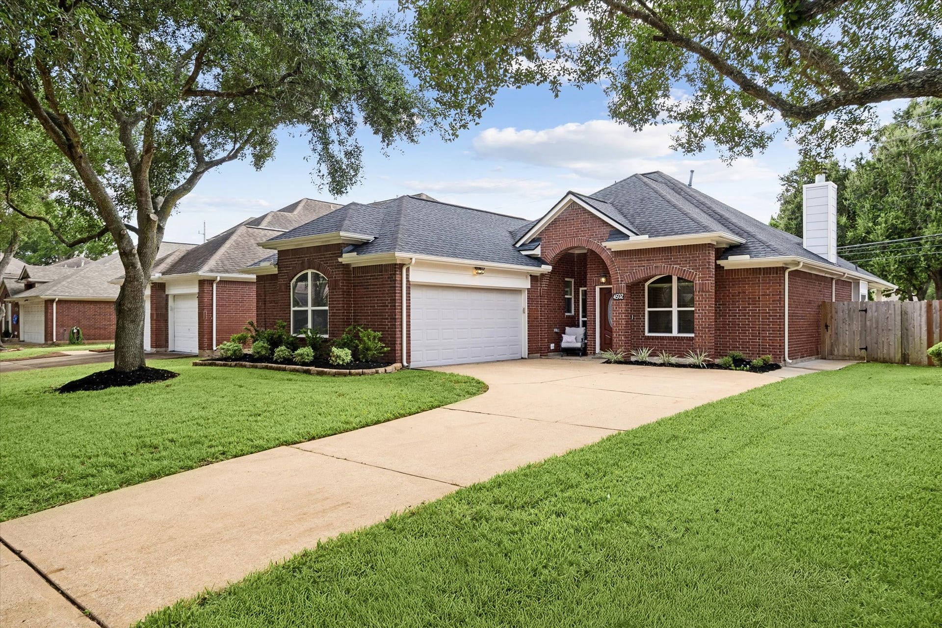 Mature trees, a spacious front lawn and inviting curb appeal welcome you home.