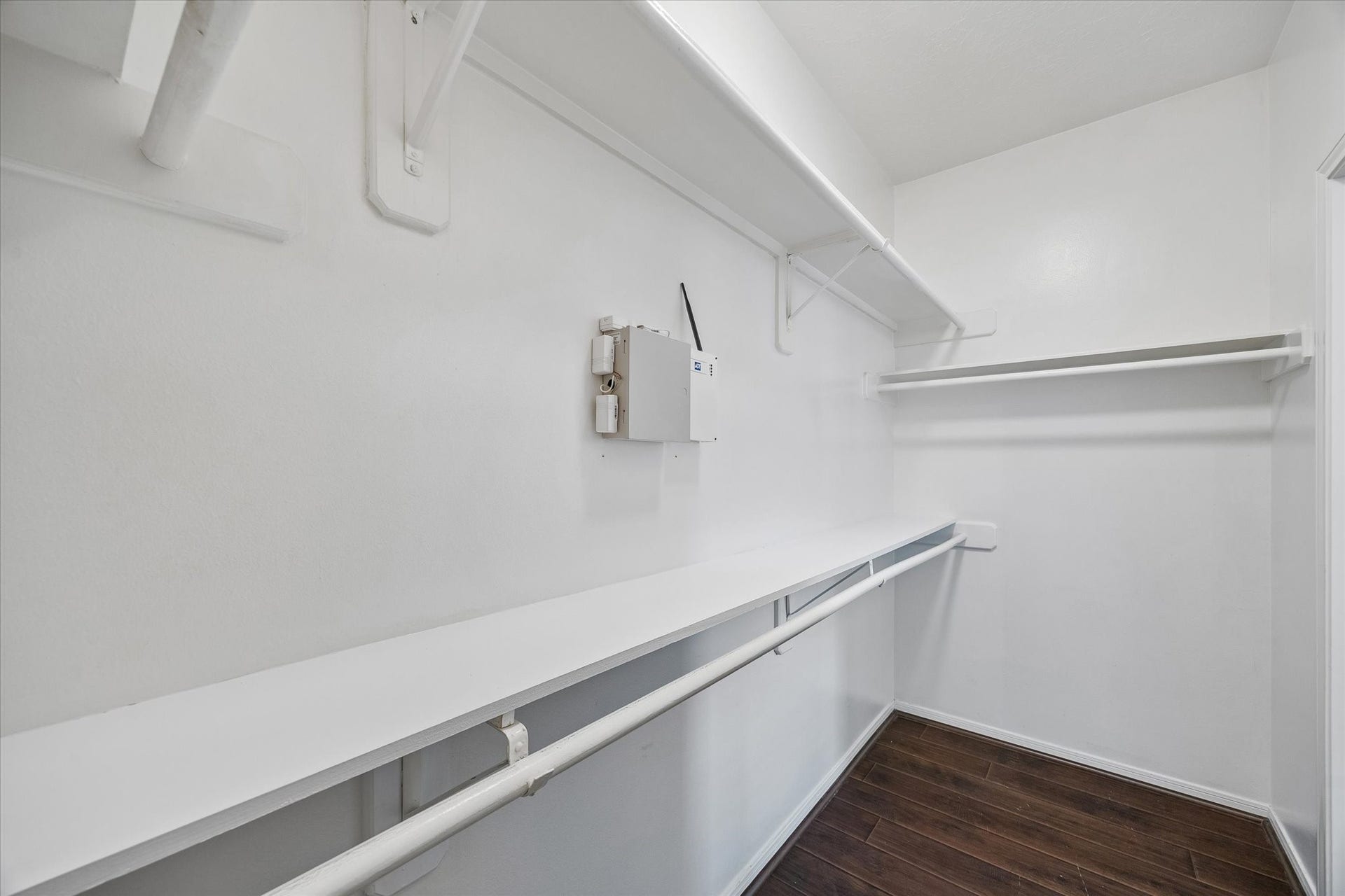 Walk-in primary closet provides plenty of storage and hanging space.