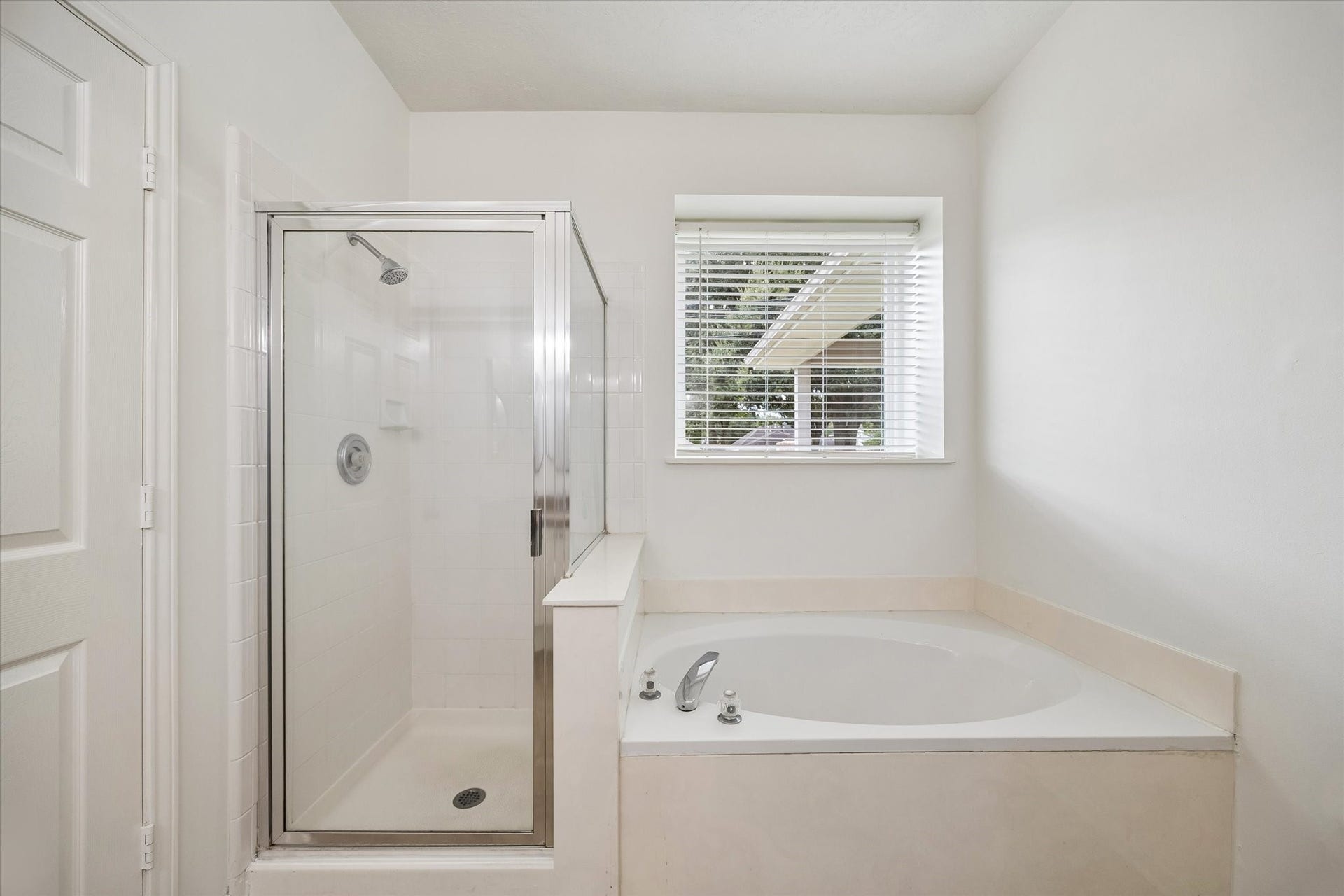 Primary bath also offers a separate soaking tub and shower with natural light.