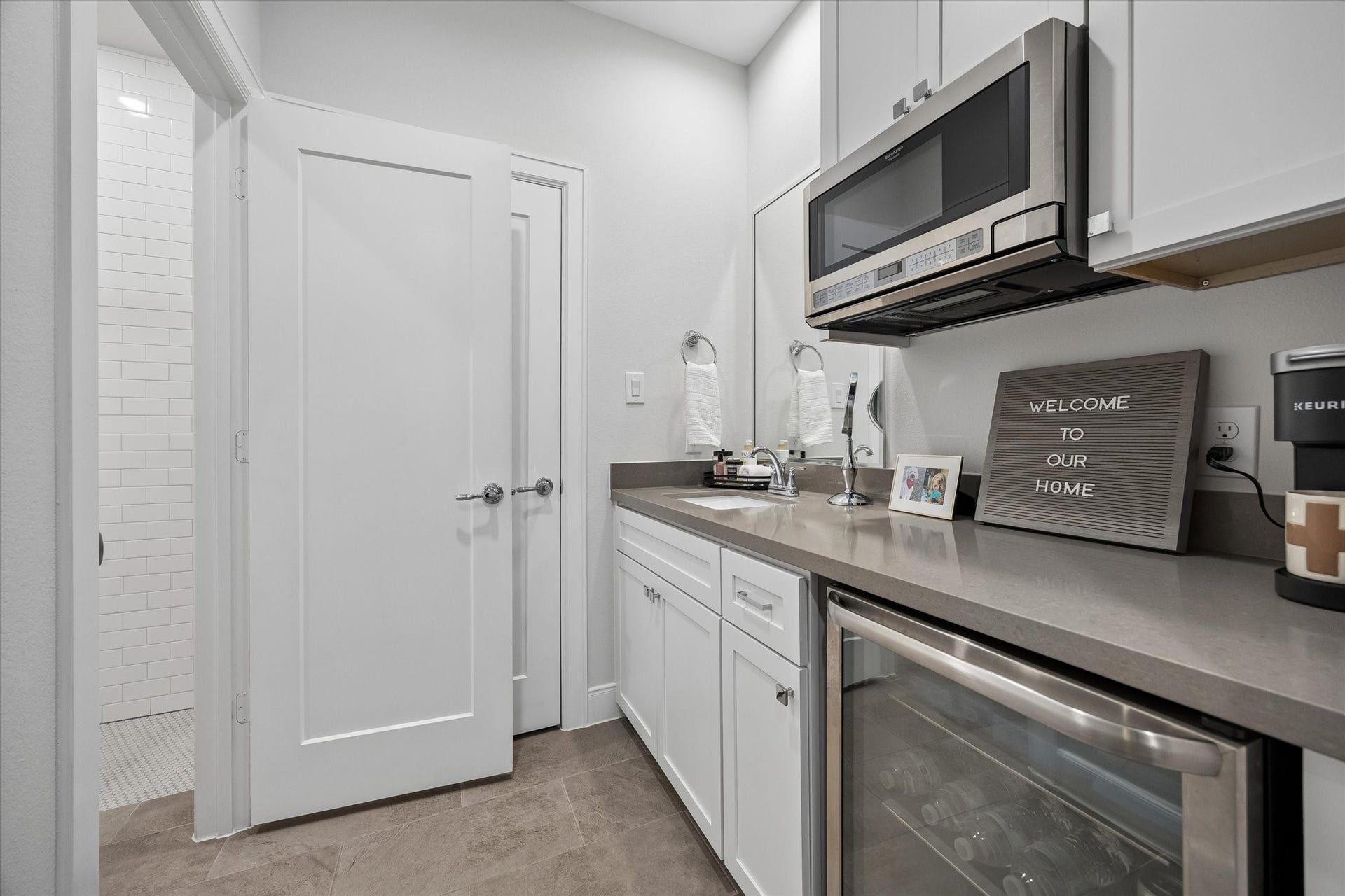 2491 W 11th Street, Houston, TX 77008 Convenient first-floor wet bar includes built-in cabinetry, counter space, a beverage refrigerator, and microwave. Located adjacent to a full bath, this flexible area adds functionality to the lower level. Separate entrance and washer/dryer connections make this first floor a true suite!