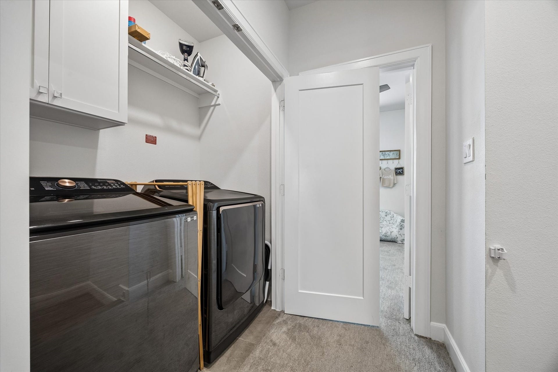 2491 W 11th Street, Houston, TX 77008 Convenient laundry area offers space for a full-size washer and dryer along with built-in cabinetry and hanging storage. Its location near the bedrooms makes everyday laundry easily accessible.