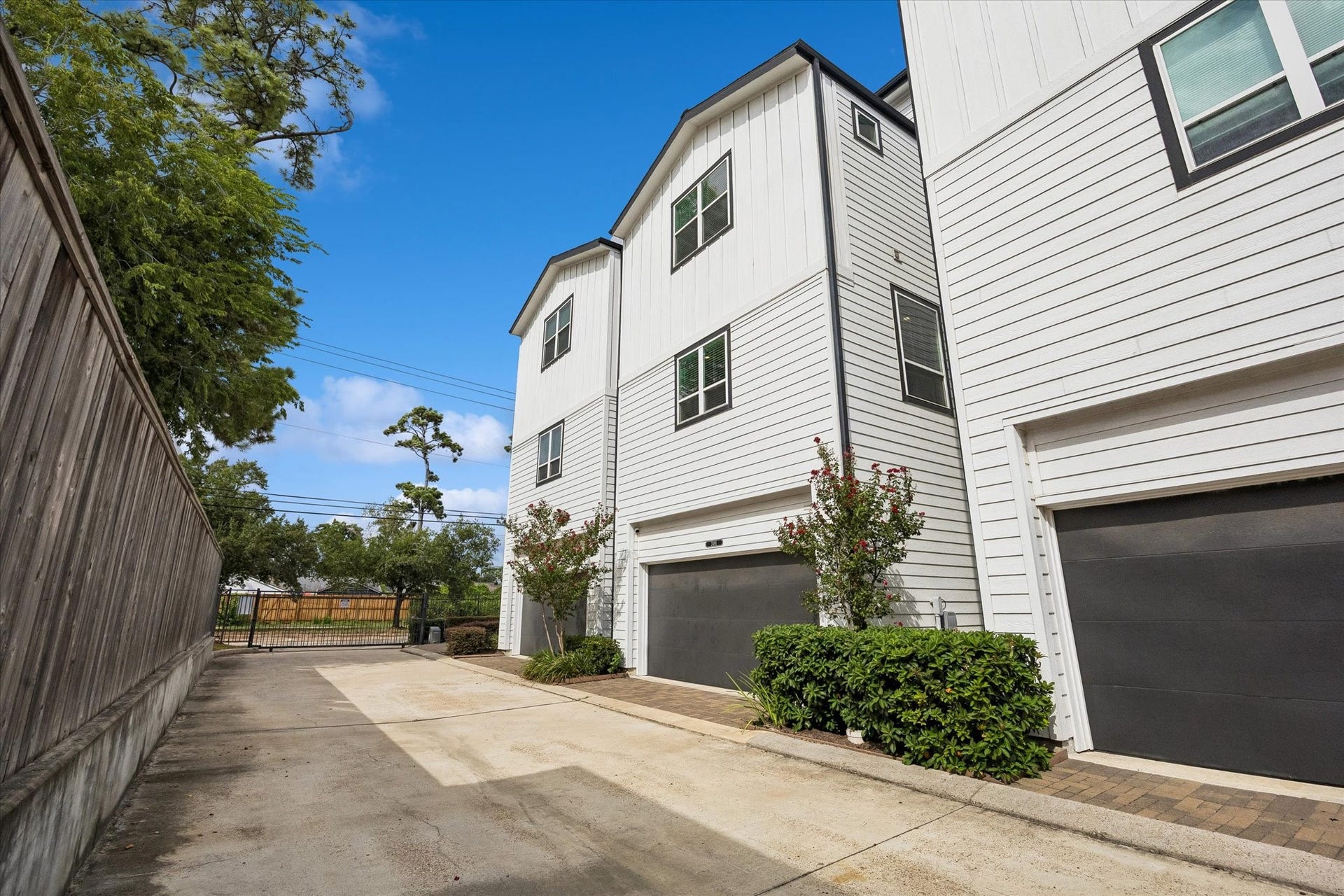 2491 W 11th Street, Houston, TX 77008 Rear exterior view highlights the homes modern architecture and attached garage. The private community drive provides convenient access to the residence.