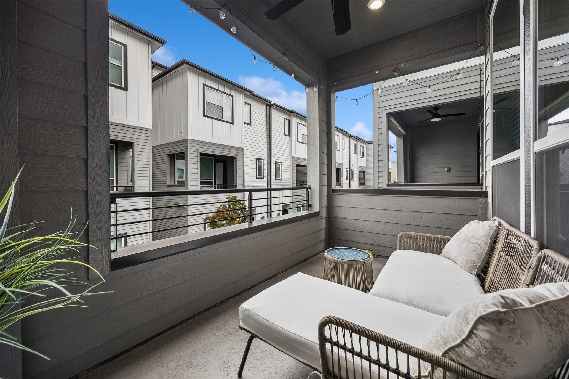 2491 W 11th Street, Houston, TX 77008 Covered outdoor balcony provides a comfortable extension of the living space with room for lounge seating. A ceiling fan and string lighting make this a great spot for relaxing or entertaining.