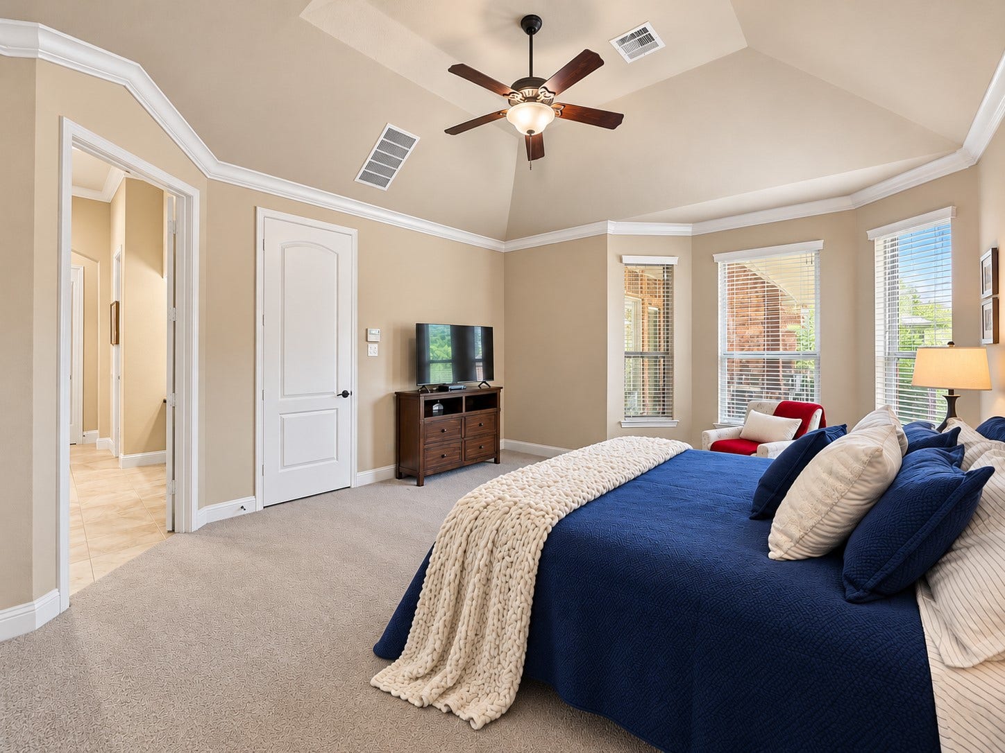 59 Tioga Place, Tomball, TX 77375 A private place to begin your morning and wind down at night, the primary suite offers a comfortable escape from the day's busy schedule. High ceilings enhance the open feel of the primary bedroom, while multiple windows bring in natural light.