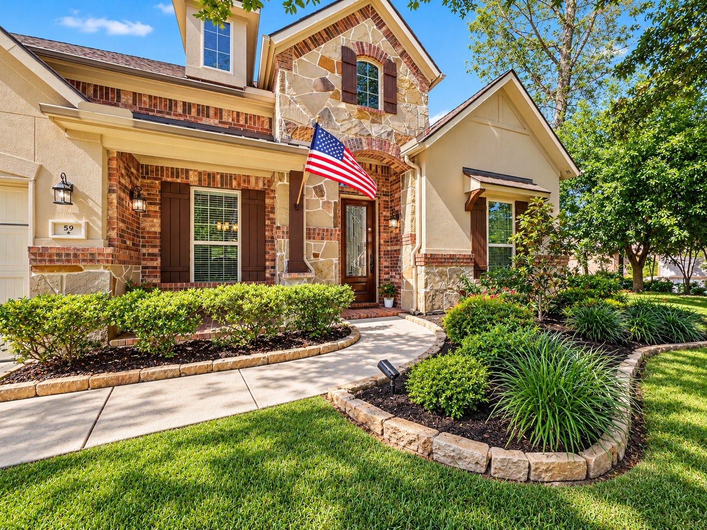 59 Tioga Place, Tomball, TX 77375 Beautifully maintained landscaping adds to the home's curb appeal, offering a warm welcome before you even step inside.