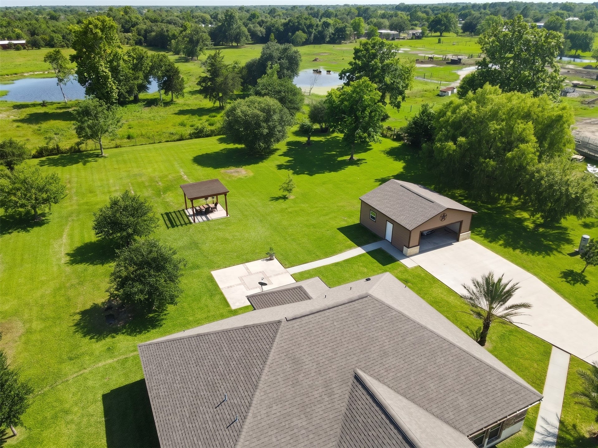 11021 32nd Street, Santa Fe, TX 77510 Discover your dream home from above, showcasing an impeccable roofline and expansive green surroundings, perfect for serene living.