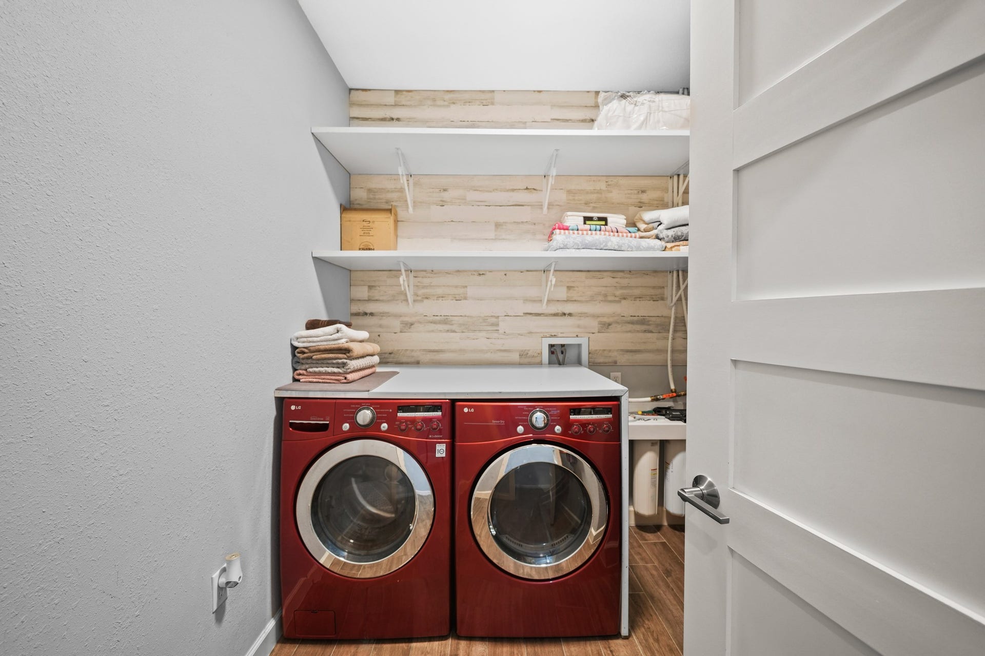 11021 32nd Street, Santa Fe, TX 77510 Laundry Room: Practical shot showing the dedicated utility space and shelving