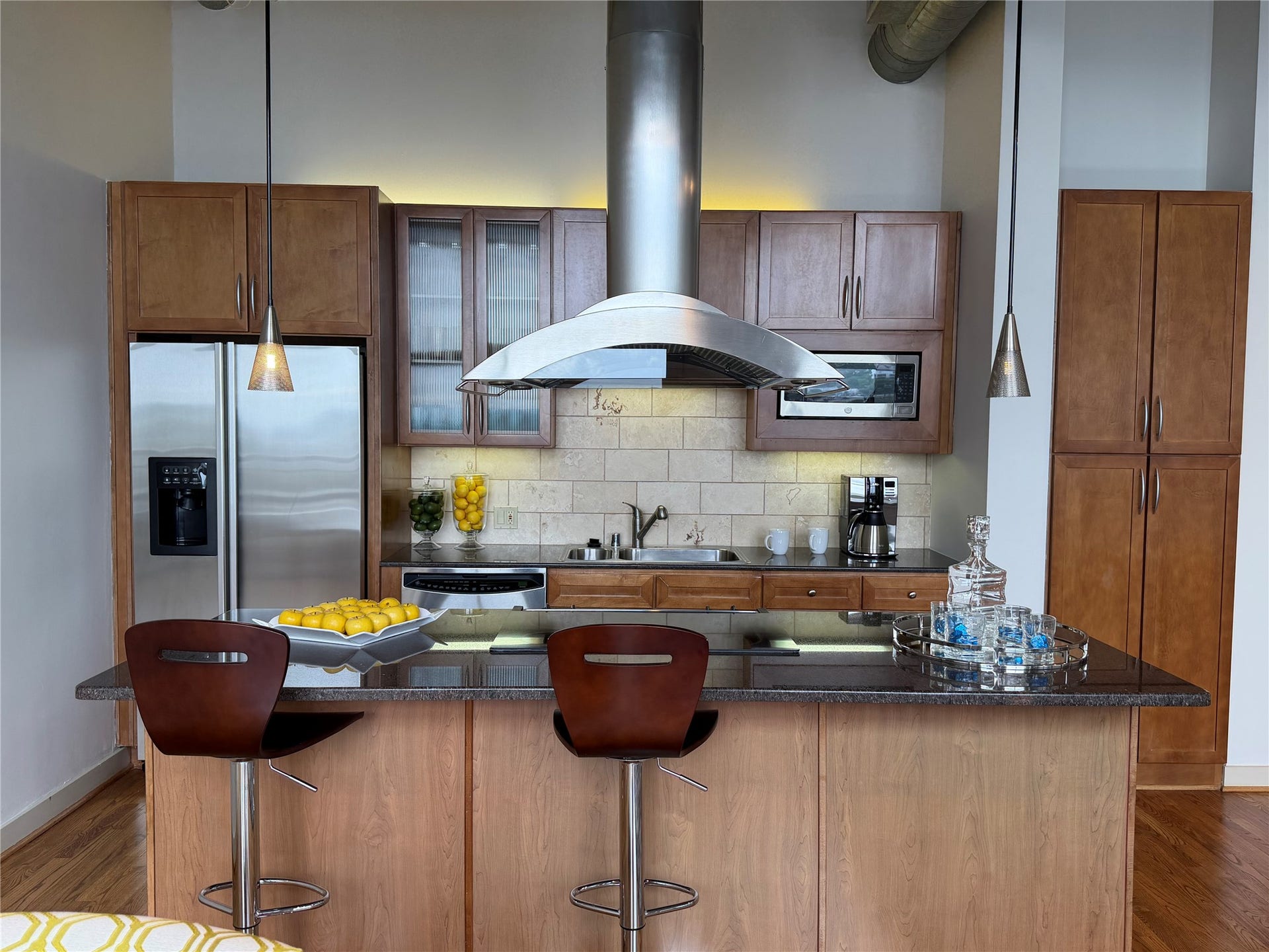 Breakfast bar in the kitchen. Hanging light fixtures and over/under cabinets lights. Stainless steel appliances and abundant storage!
