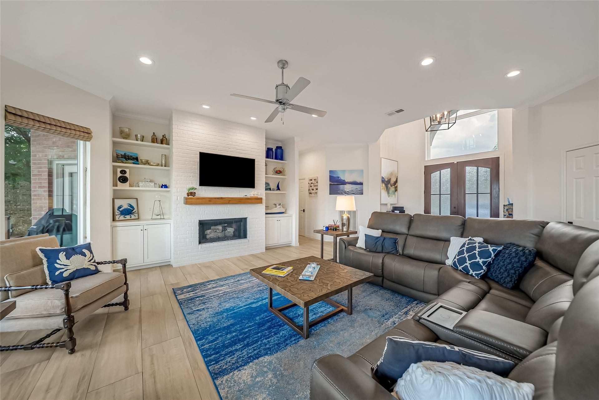 318 Bayshore Drive, Montgomery, TX 77356 Centered around a beautifully crafted gas fireplace with custom built-ins, the family room offers a warm and inviting atmosphere designed for both quiet evenings and effortless entertaining.