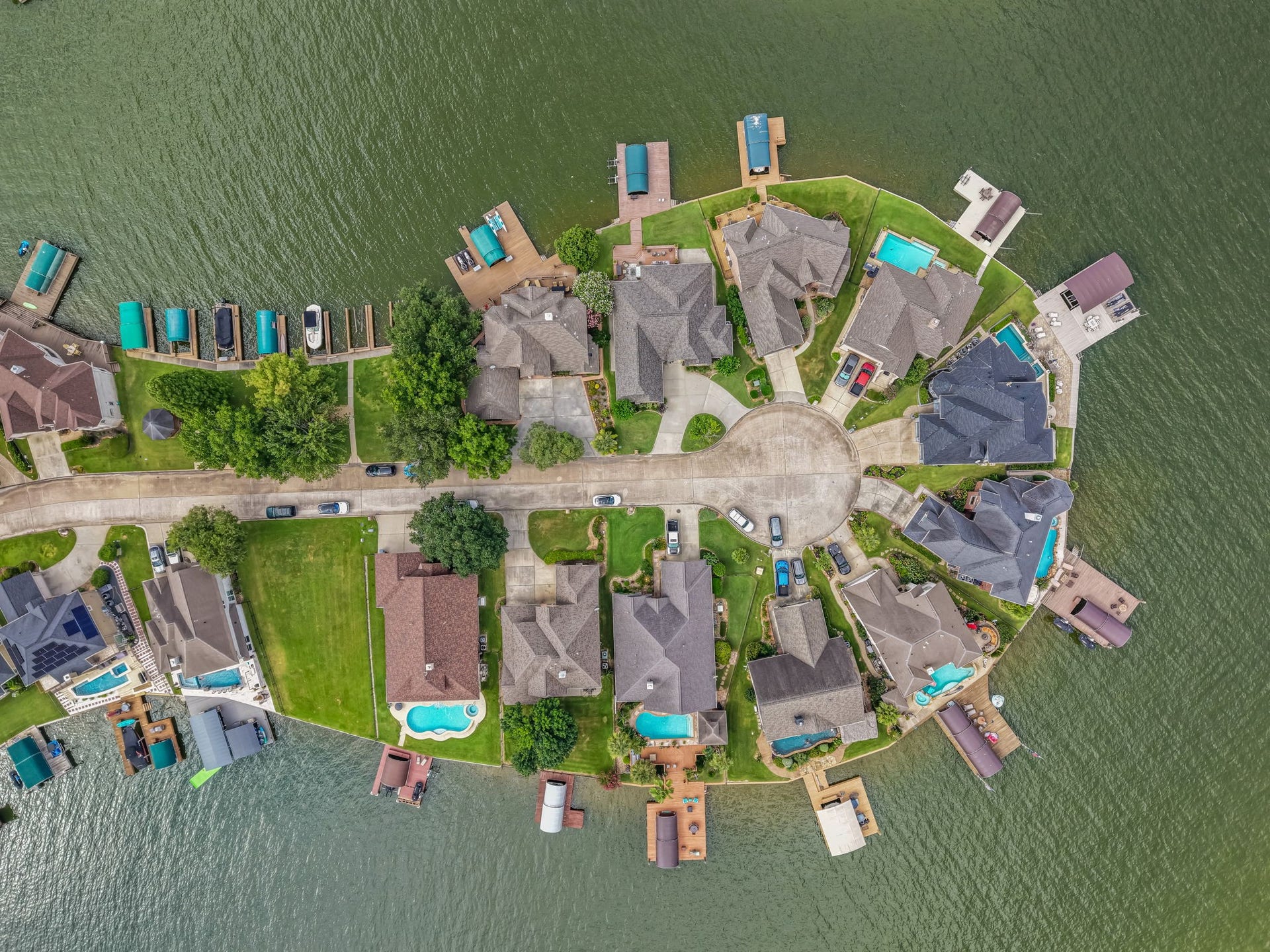 318 Bayshore Drive, Montgomery, TX 77356 The aerial perspective highlights the property's impressive scale, showcasing its expansive waterfront frontage, private dock, beautifully maintained grounds, and exceptional outdoor living spaces.