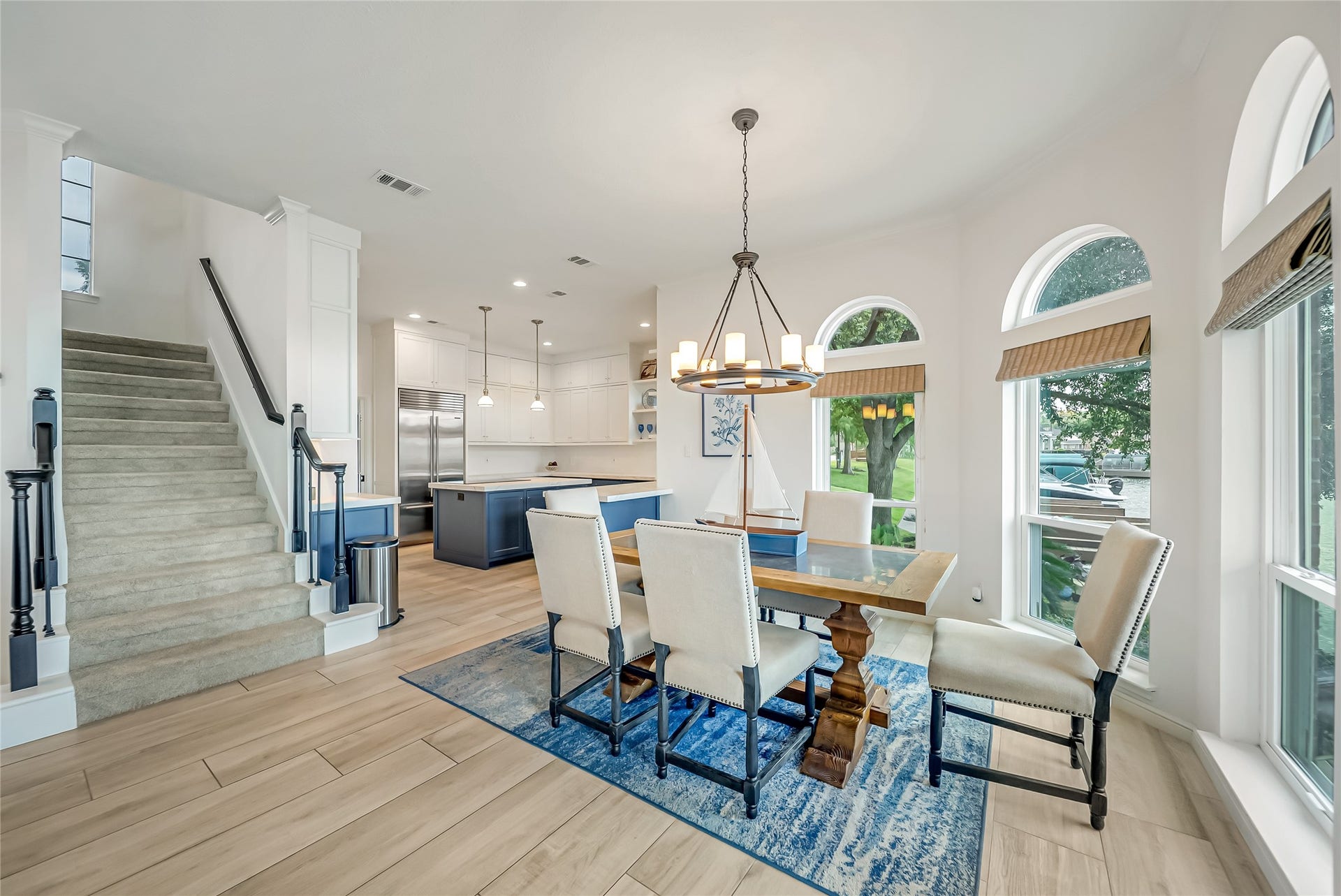 318 Bayshore Drive, Montgomery, TX 77356 Framed by beautiful architectural windows, the dining area provides a light-filled space that effortlessly connects the kitchen and living room, making entertaining both comfortable and convenient.