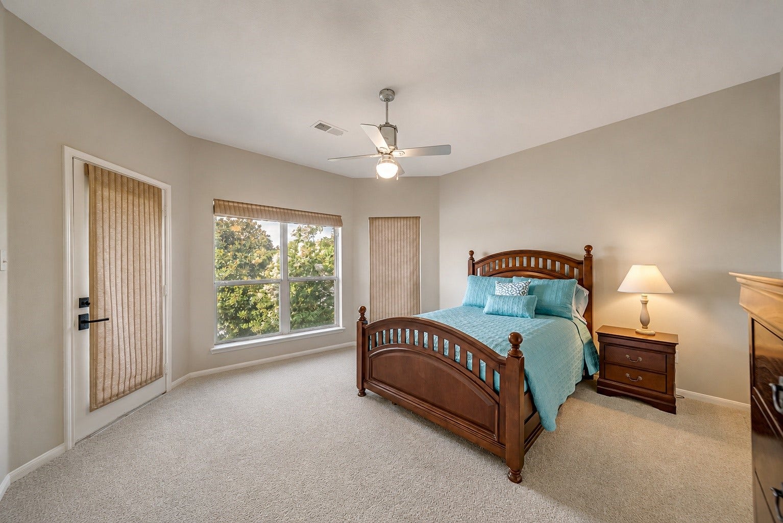 318 Bayshore Drive, Montgomery, TX 77356 Bedroom 4 offers a spacious layout with large windows overlooking the lake, filling the room with natural light and showcasing peaceful waterfront views. A private door provides direct access to the wraparound balcony.