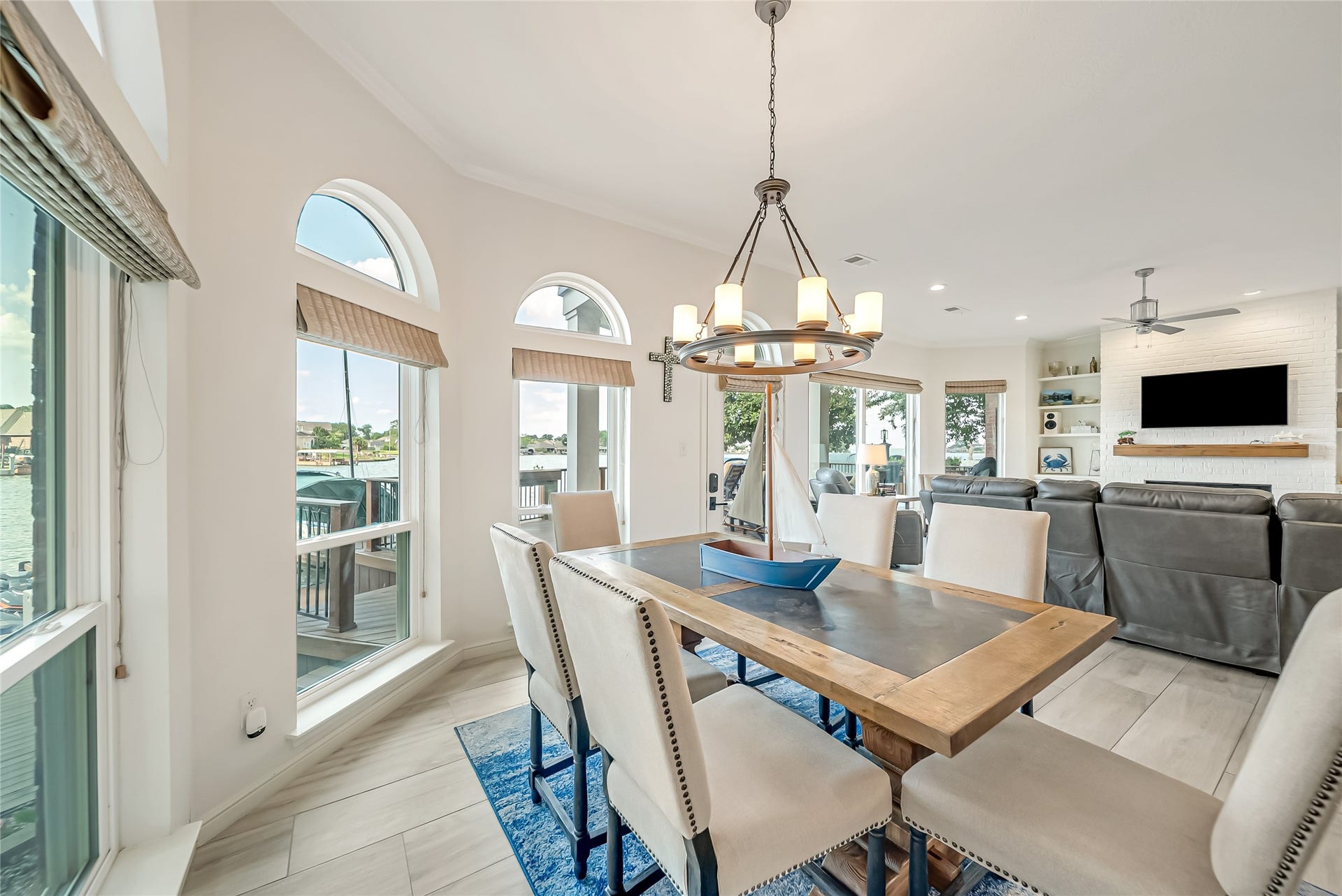 318 Bayshore Drive, Montgomery, TX 77356 Thoughtfully designed to embrace its waterfront setting, the open-concept living and dining areas flow effortlessly together, where expansive windows frame breathtaking lake views and fill the home with an abundance of natural light.
