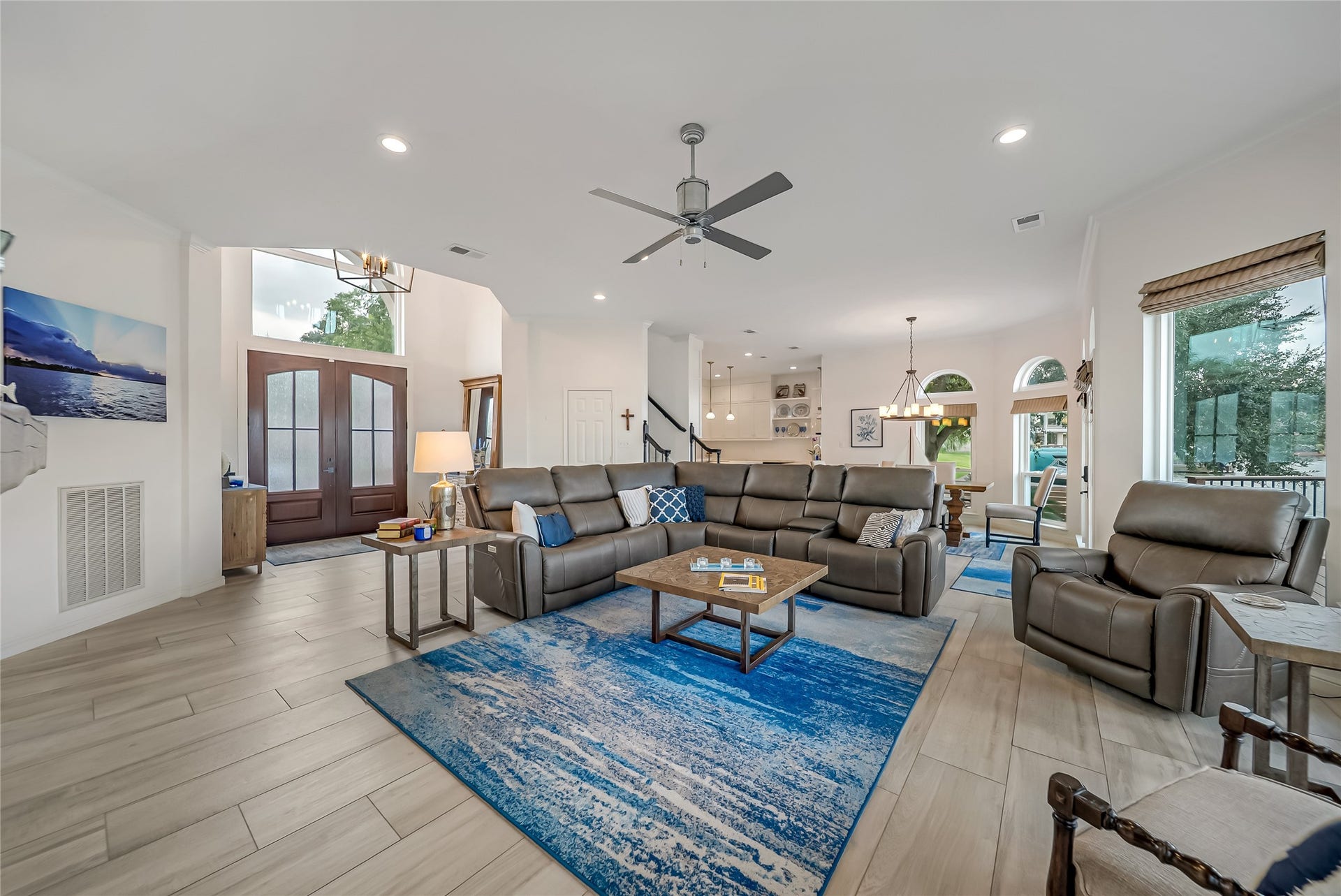 318 Bayshore Drive, Montgomery, TX 77356 The spacious main living area is thoughtfully positioned to embrace the surrounding lake views, seamlessly connecting the living room, dining area, and beautifully remodeled chef's kitchen into one inviting gathering space.