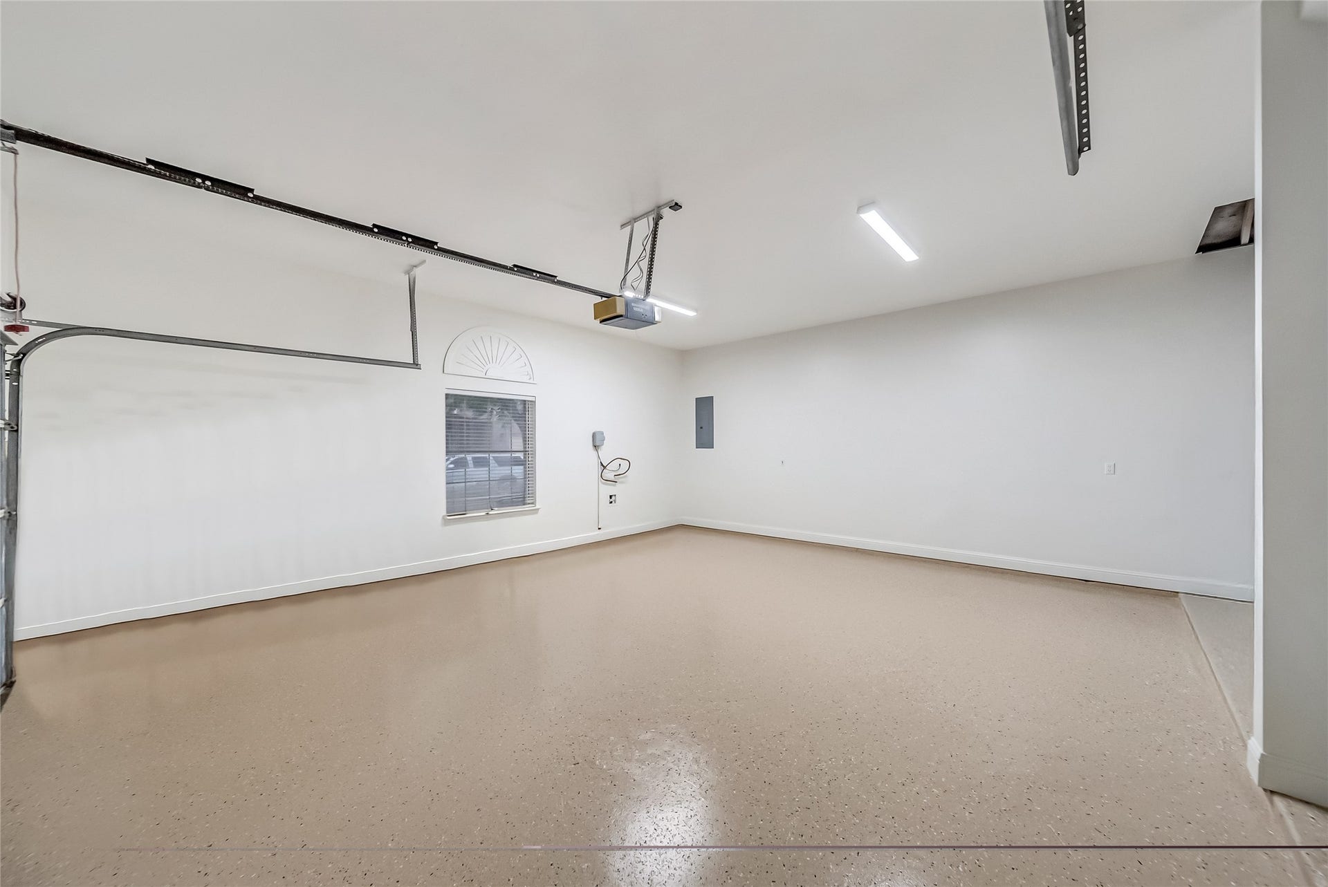 318 Bayshore Drive, Montgomery, TX 77356 A true extension of the home's thoughtful design, the oversized garage features epoxy flooring, a dedicated storage nook, direct access to the backyard, and a walk-up attic that provides exceptional storage for seasonal dcor, recreational equipment, and more.
