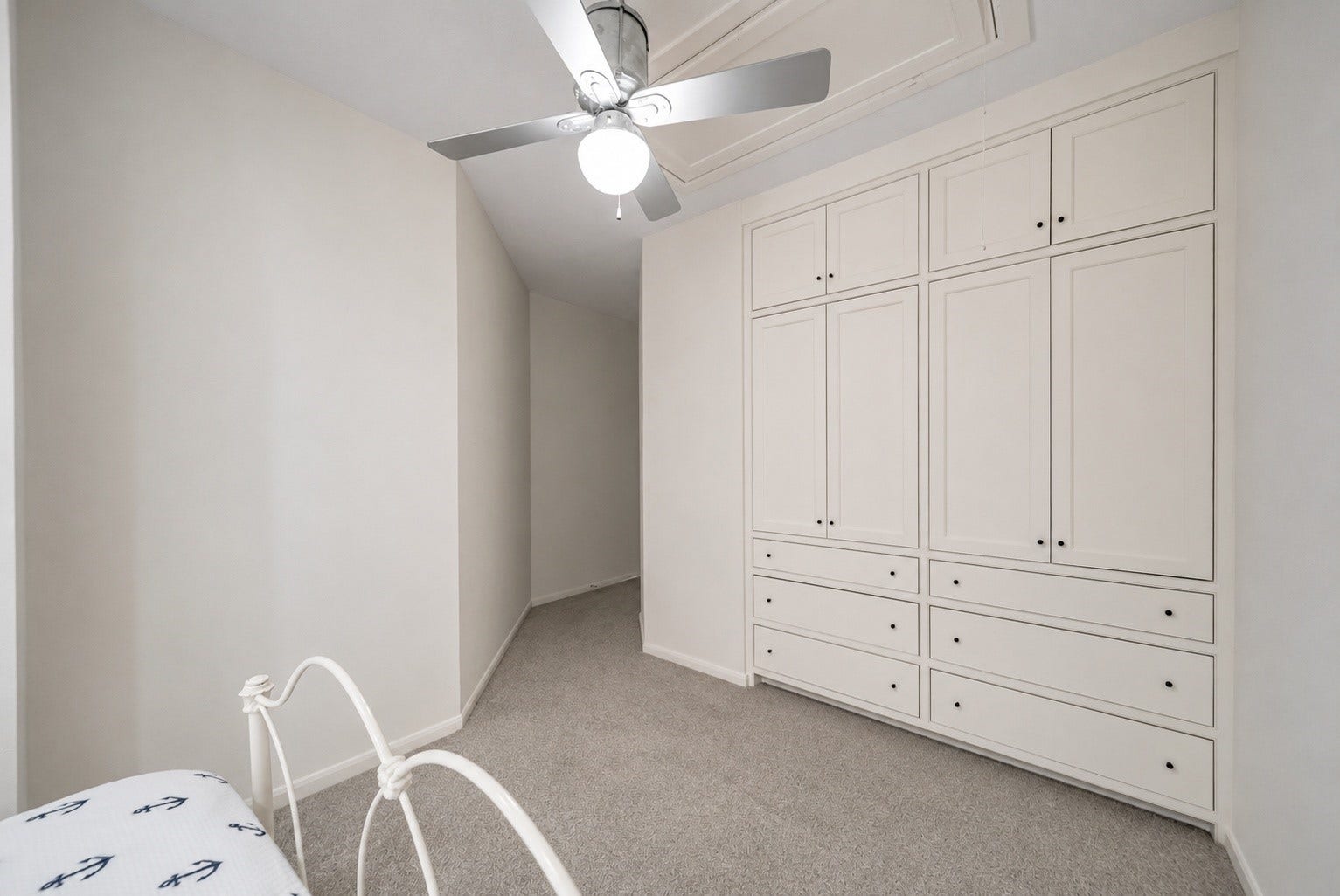 318 Bayshore Drive, Montgomery, TX 77356 Bedroom 2 is thoughtfully designed with a full wall of custom built-in cabinetry, offering extensive storage through floor-to-ceiling cabinets and multiple drawers.